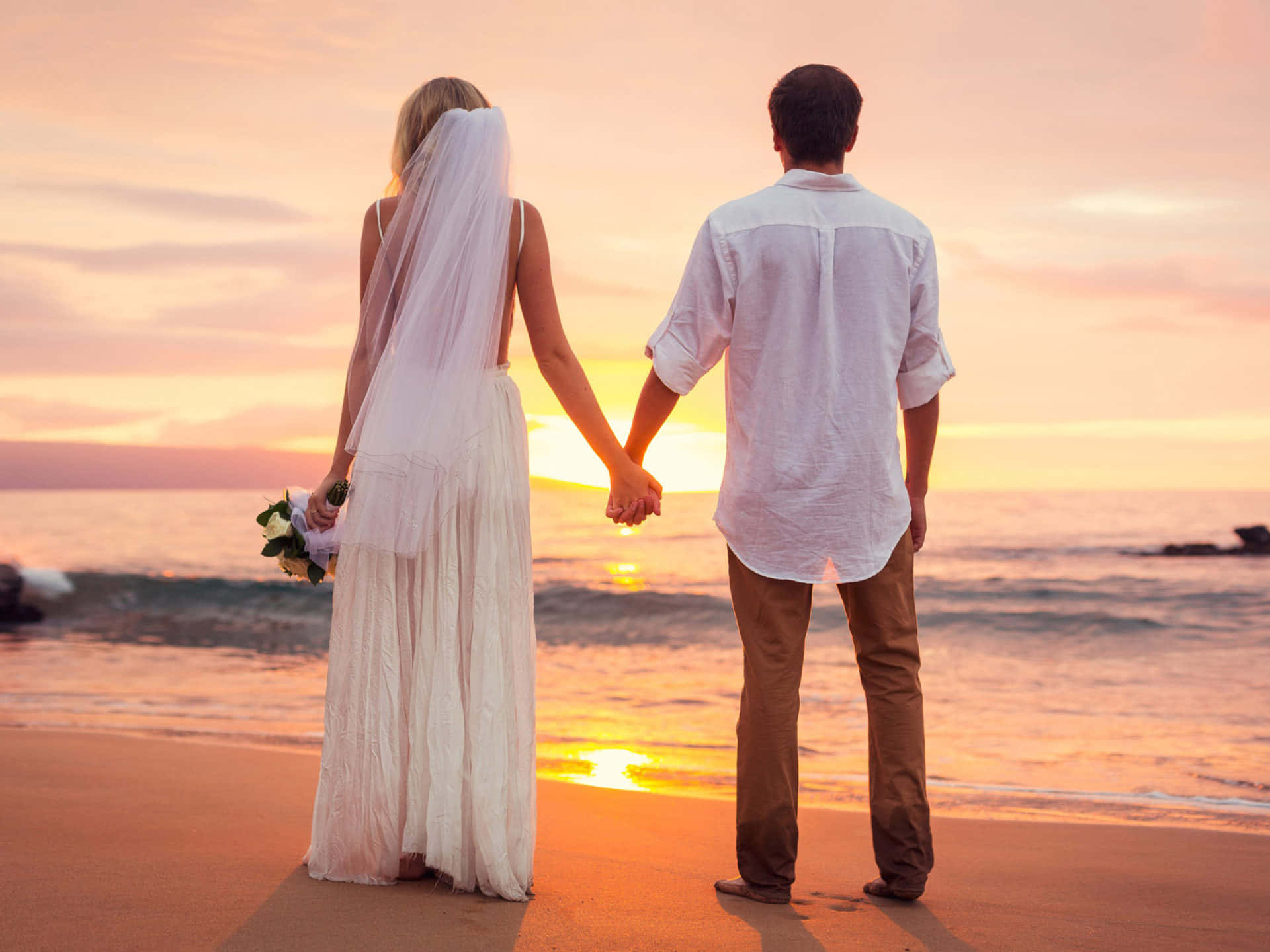 Romantic Couple Enjoying a Beautiful Sunset at the Beach Wallpaper