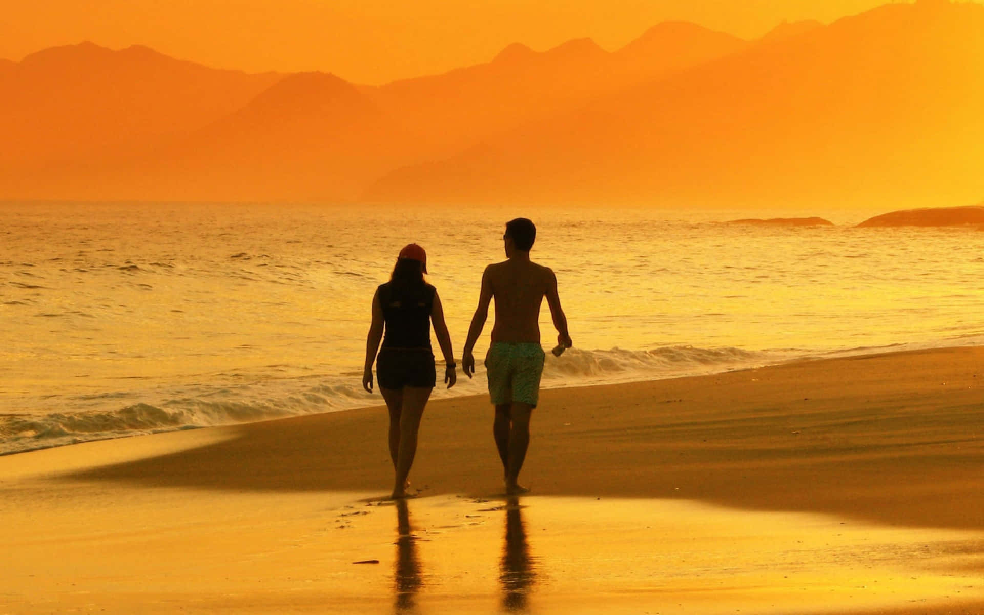 Romantic sunset walk on the beach Wallpaper