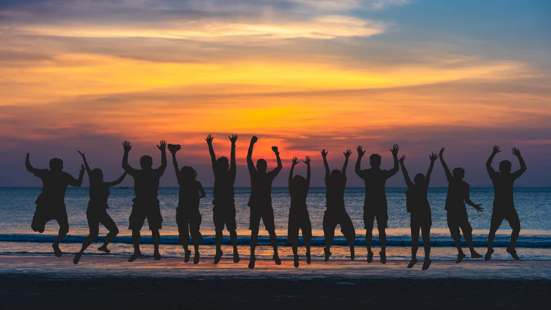 Caption: Vibrant Beach Party at Golden Hour Wallpaper