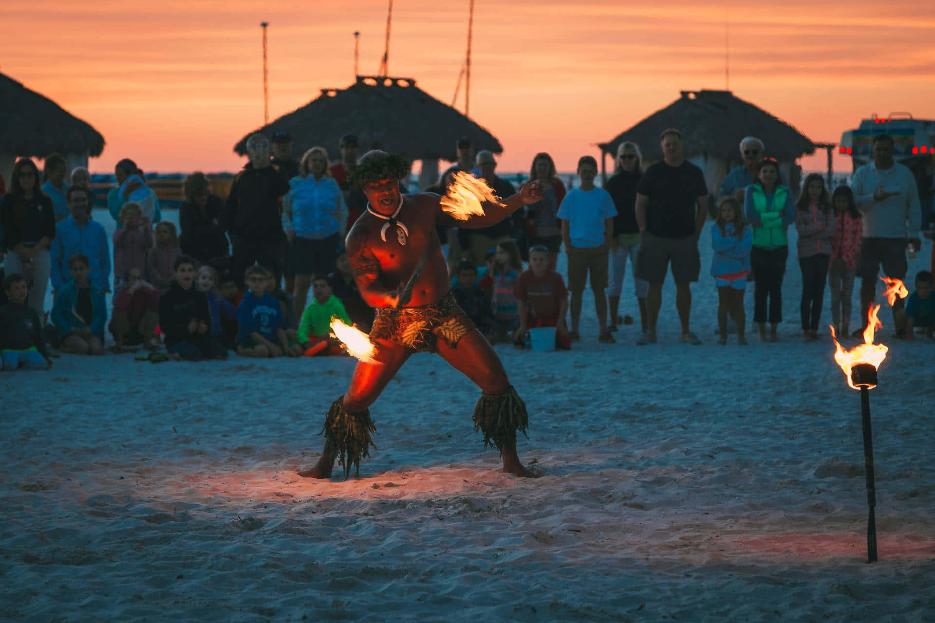 A Vibrant Beach Party Under the Sunset Sky Wallpaper