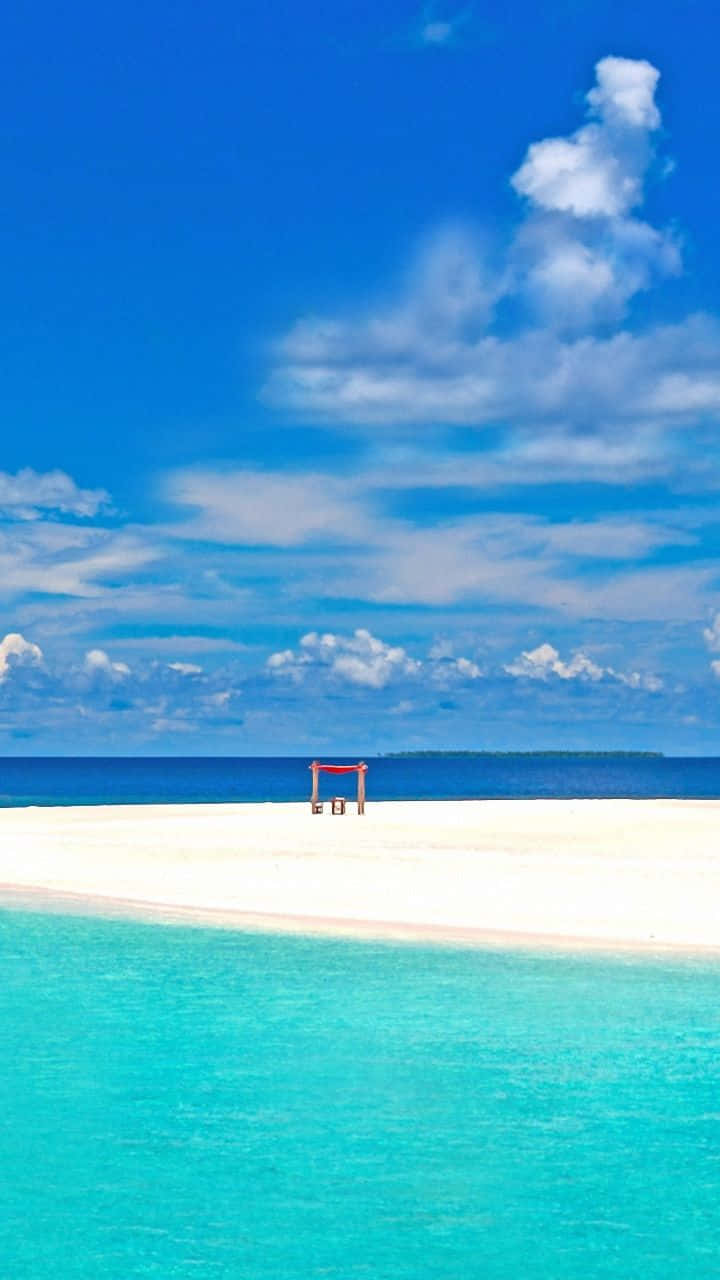 Godersiil Sole E La Sabbia Con Il Telefono Da Spiaggia Sfondo