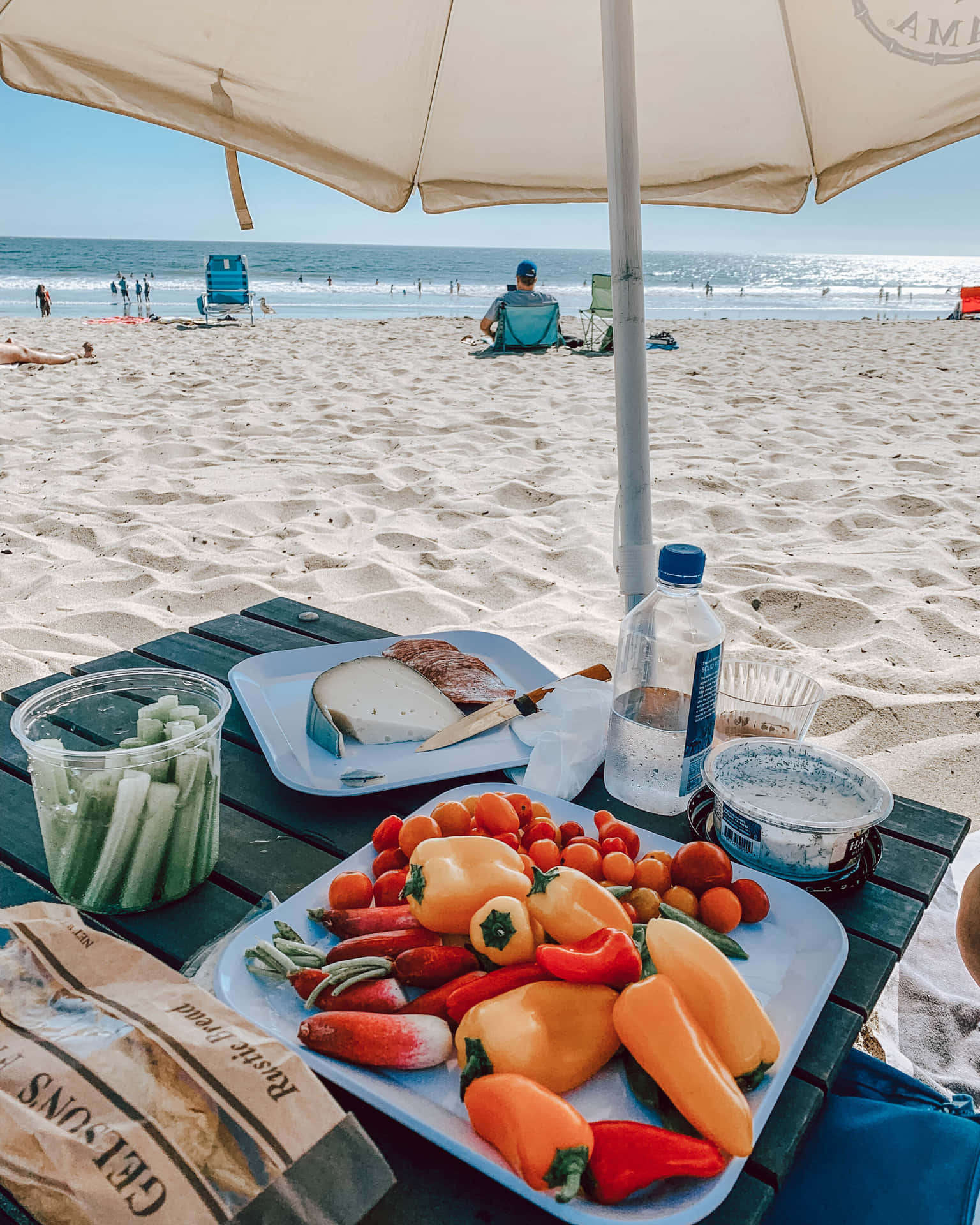 Serene Beach Picnic Setup with Sunshine Wallpaper