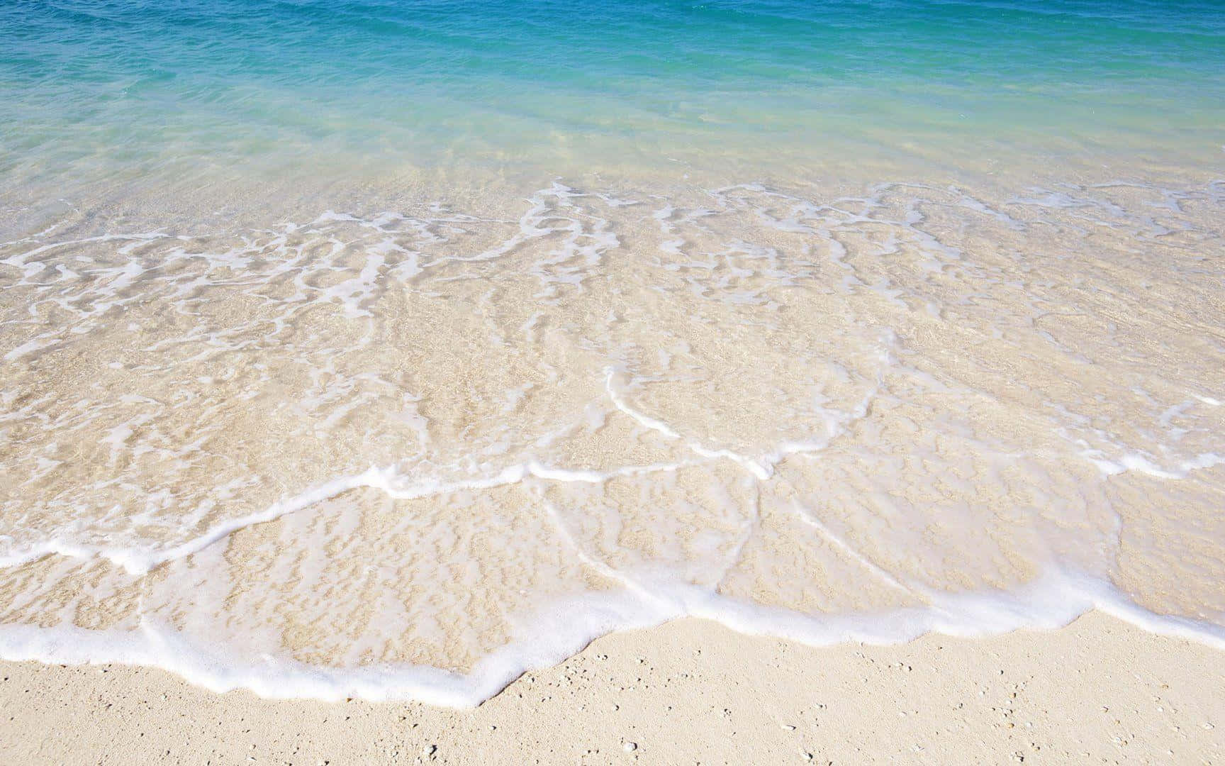 Tranquil beach with golden sand and gentle waves Wallpaper