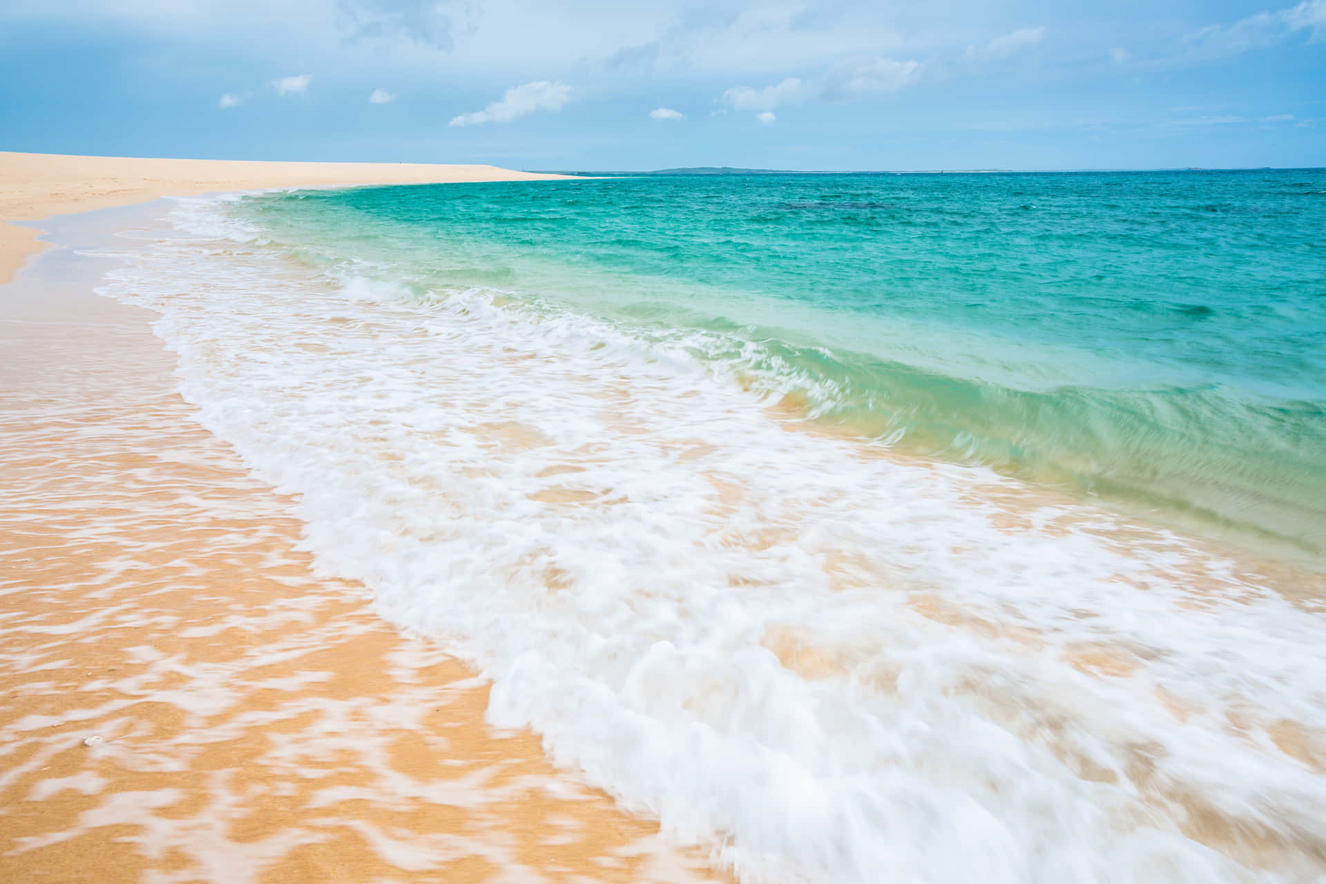 Serene tropical beach with golden sand Wallpaper