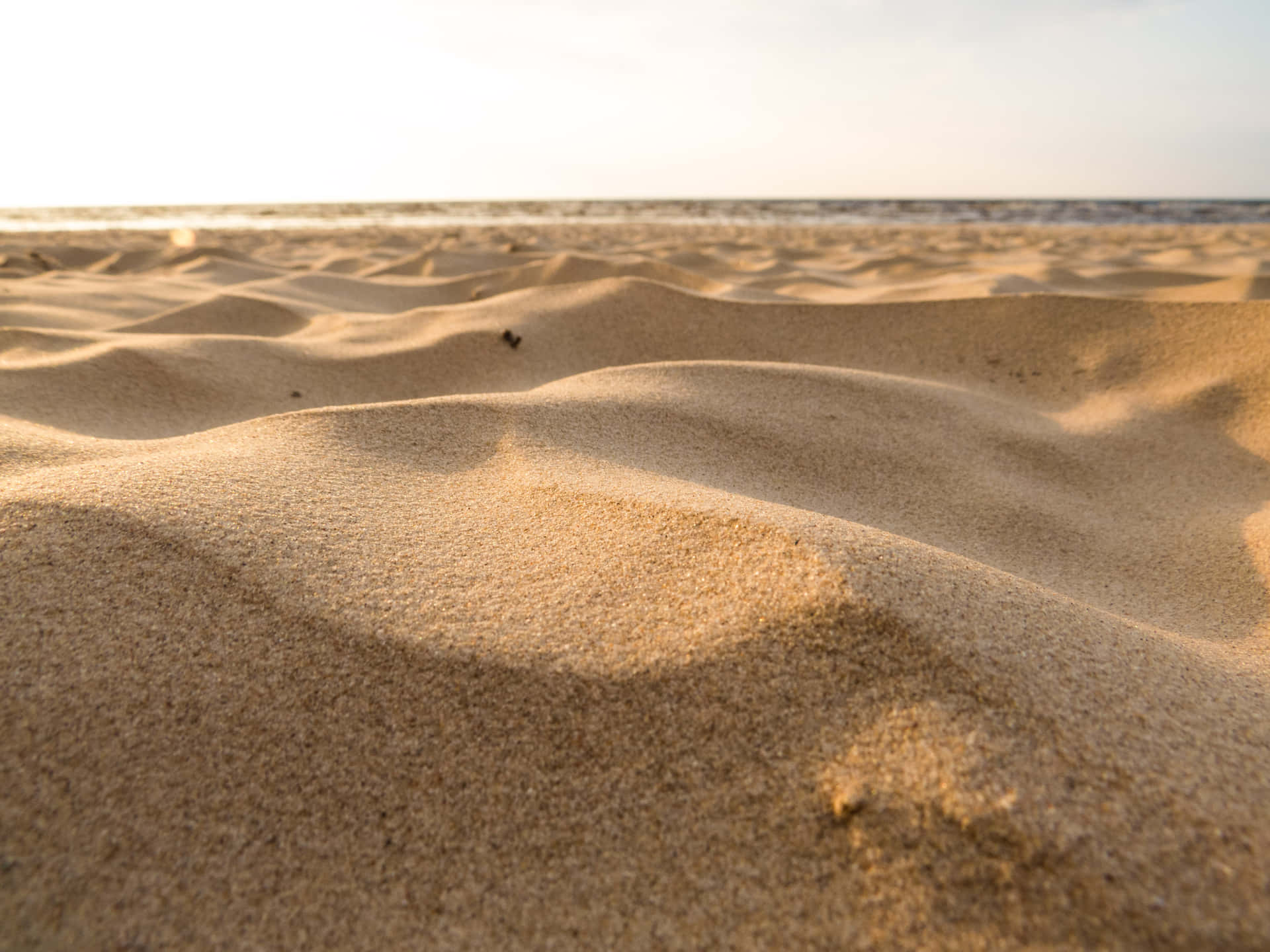 Beautiful Sunlit Beach Sand Wallpaper