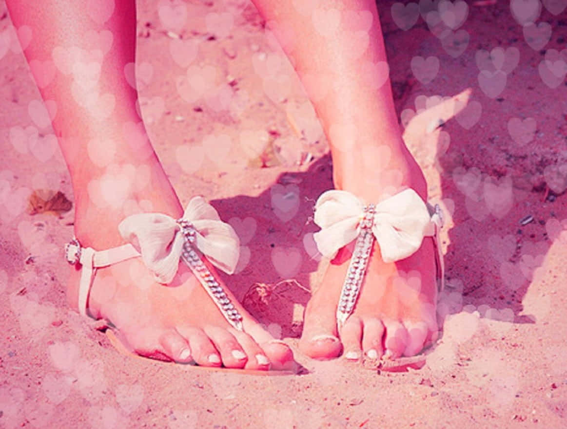Vibrantly Colored Beach Sandals on Sun-soaked Sand Wallpaper