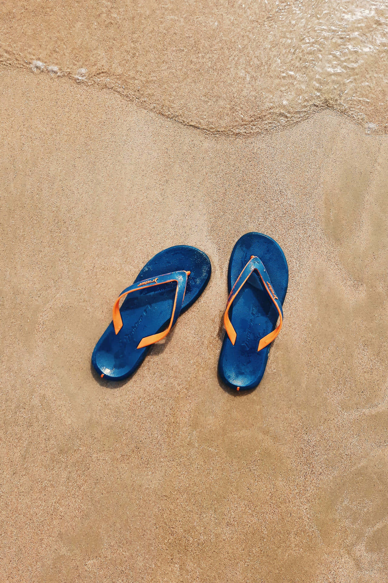 Stylish Beach Sandals on Vibrant Shore Wallpaper