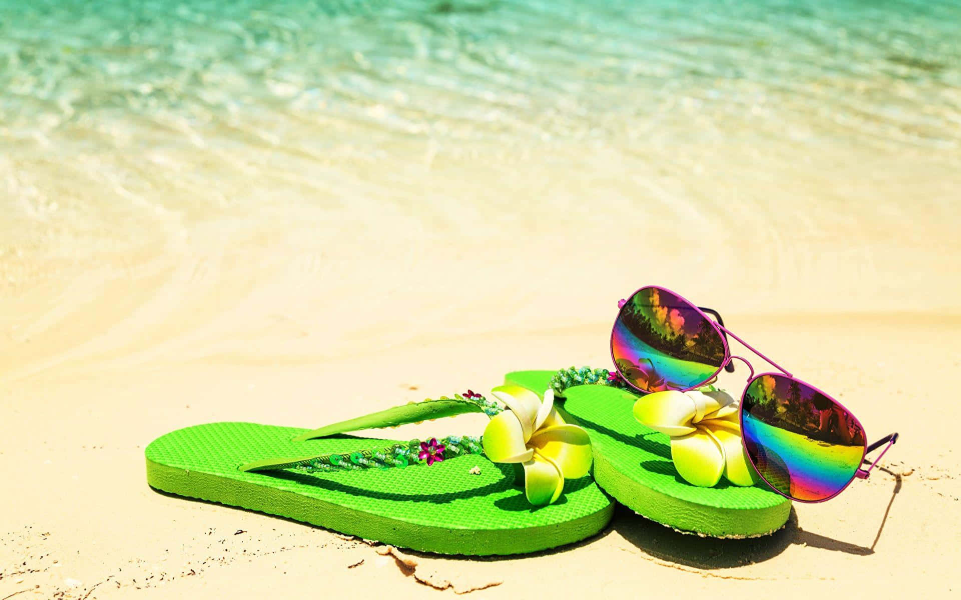 Download Vibrant Beach Sandals on Sandy Shore Wallpaper | Wallpapers.com