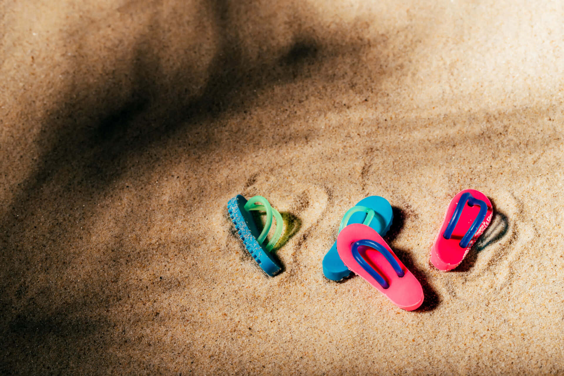Vibrant Beach Sandals on Sunny Seashore Wallpaper