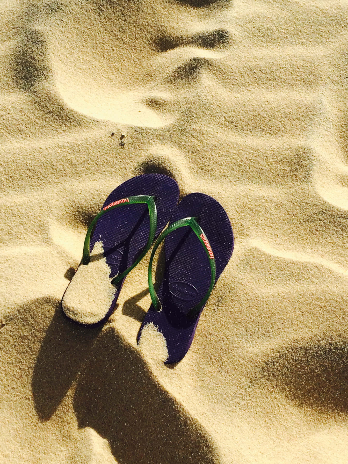 Vibrant Beach Sandals on the Sand Wallpaper