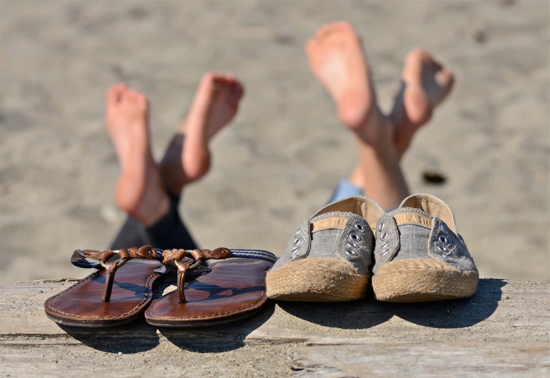 Tropical Beach Sandals on a Sunny Shoreline Wallpaper