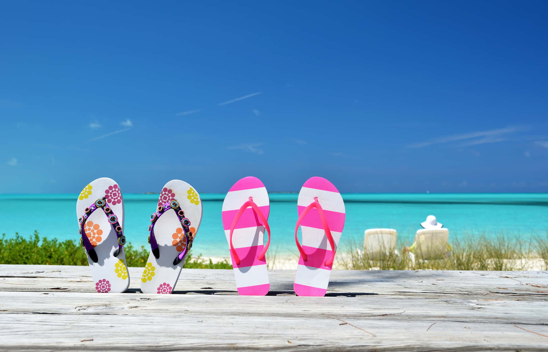 Relaxing Beach Day with Colorful Sandals Wallpaper