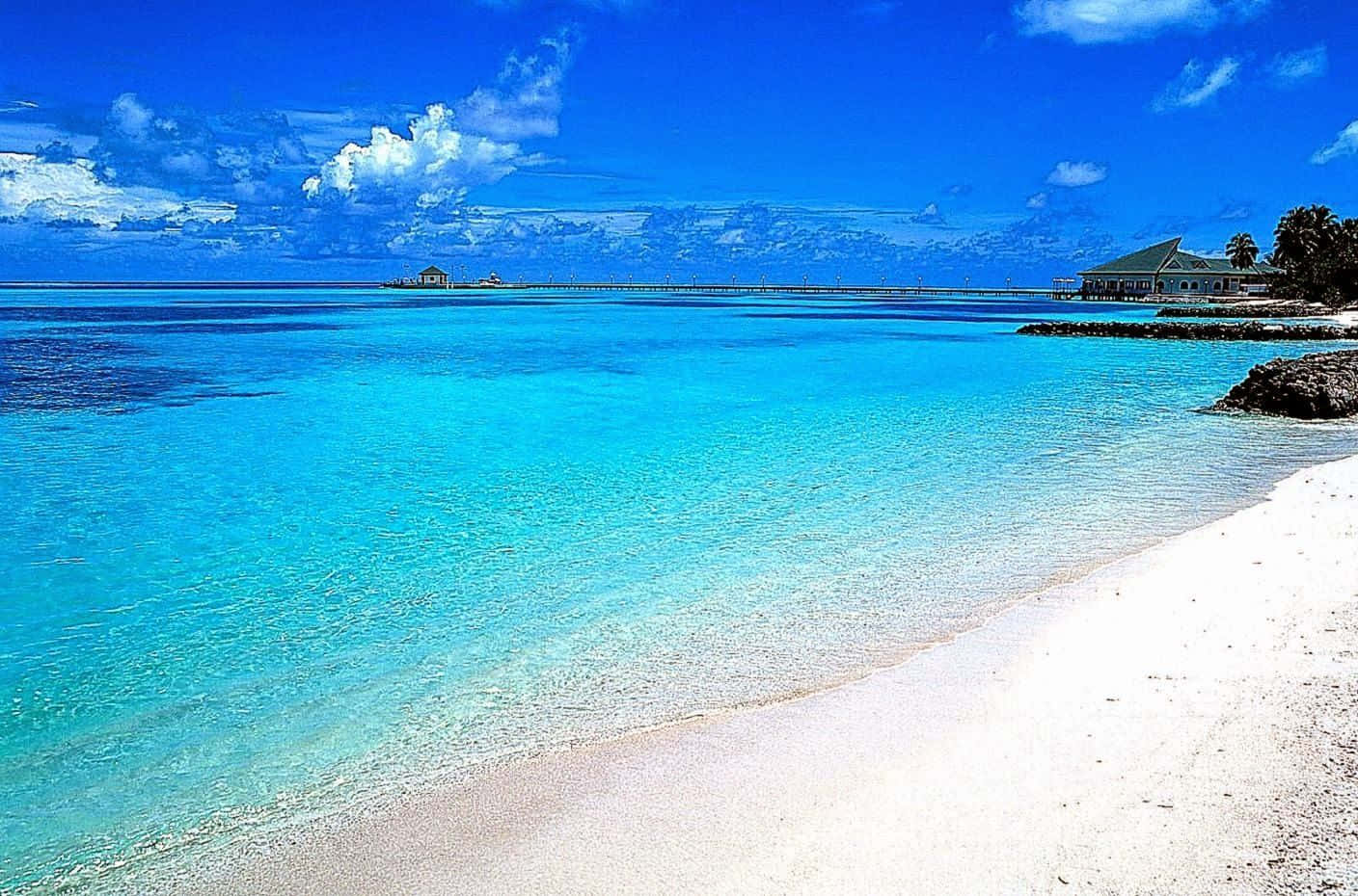 a beach with clear blue water and sand