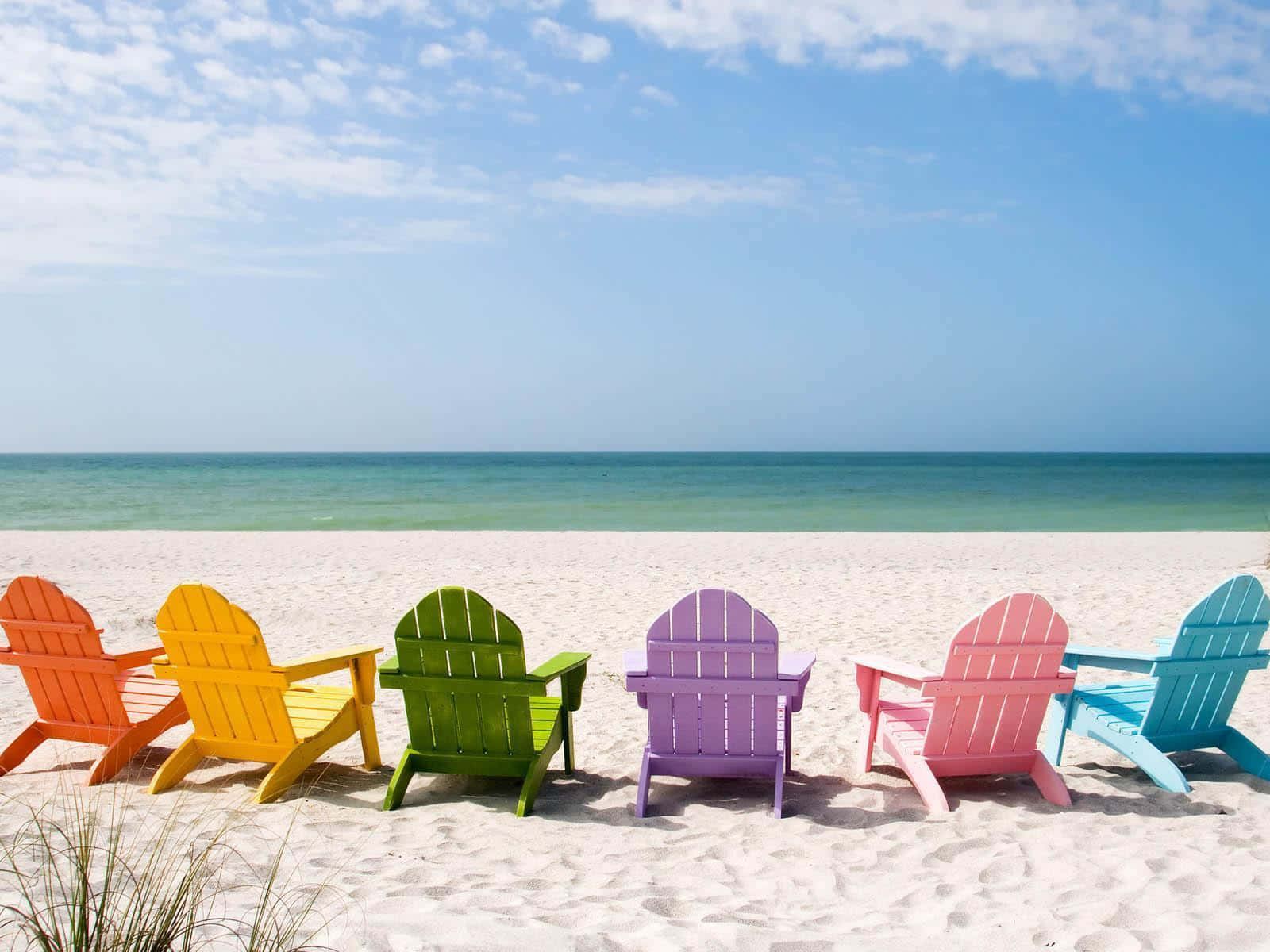 colorful adirondack chairs on the beach