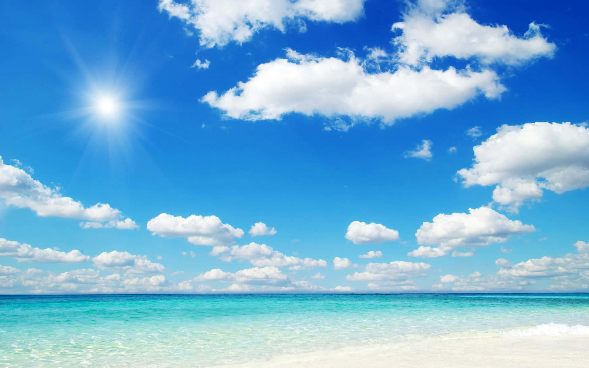 Take in the beauty of a golden beach beneath a majestic sky Wallpaper