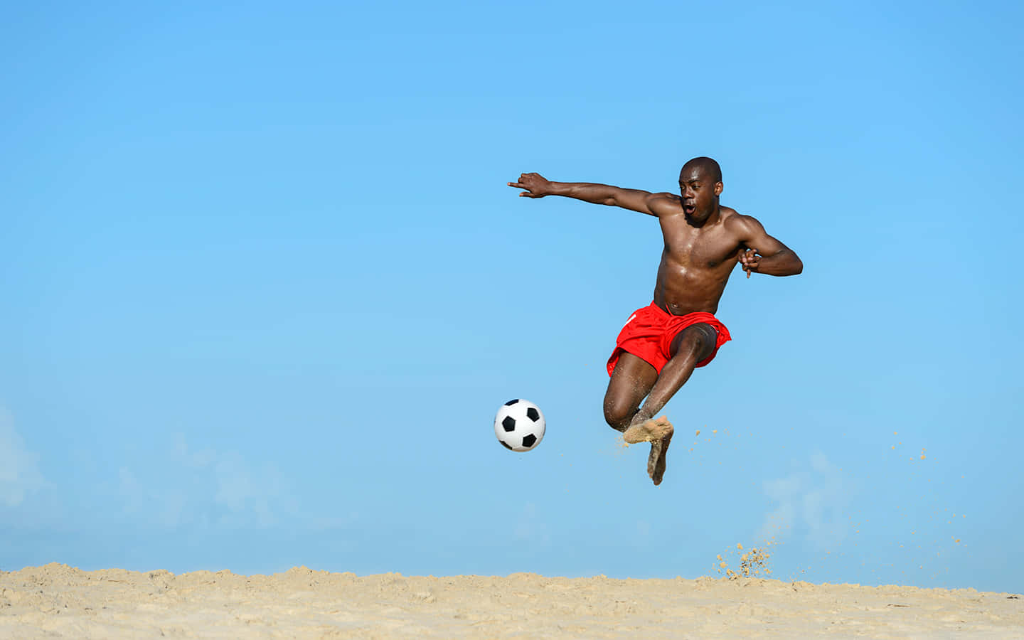 Beach Soccer Athlete Mid Air Kick Wallpaper