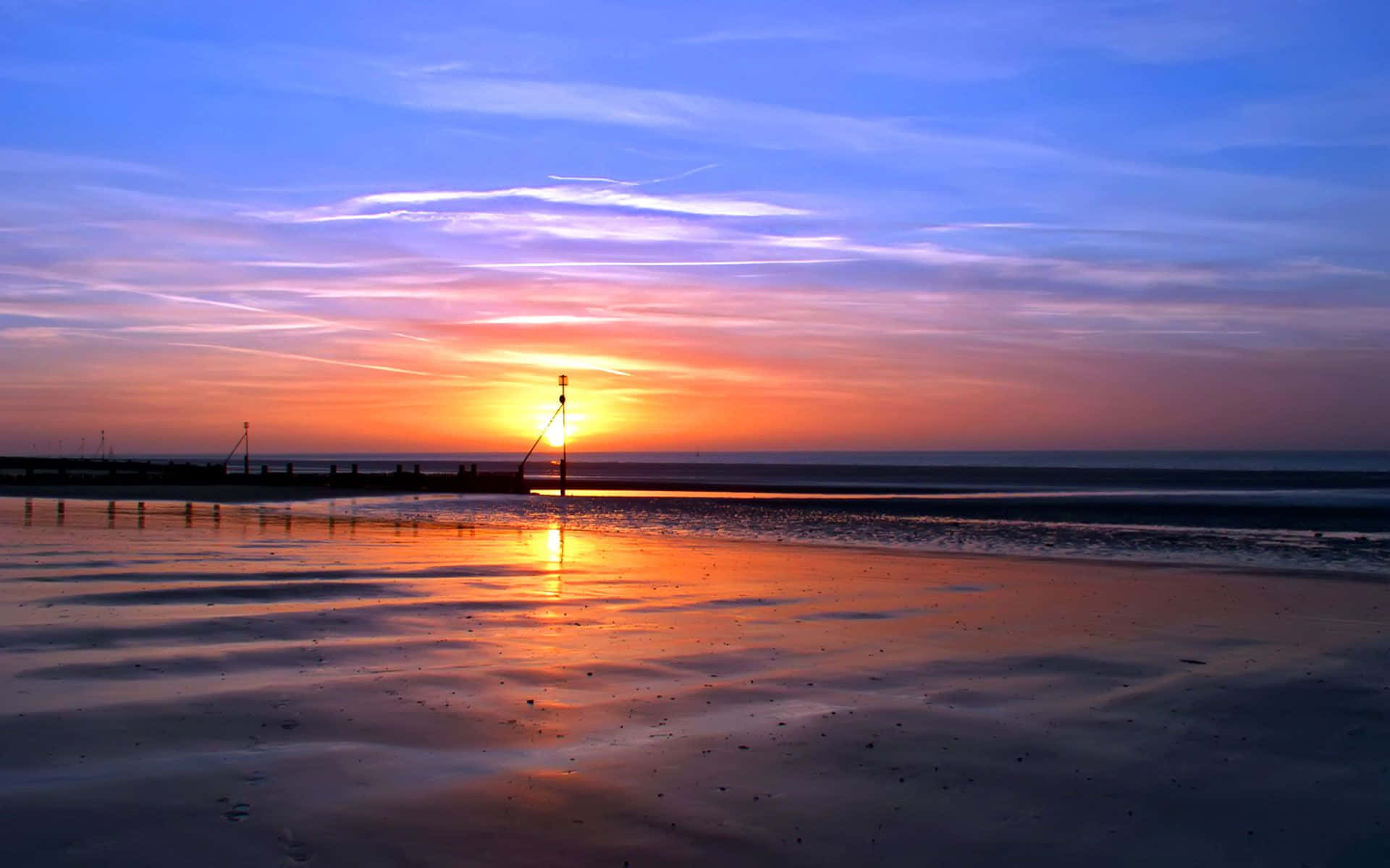 Enjoy the golden beauty of a tranquil beach sunset