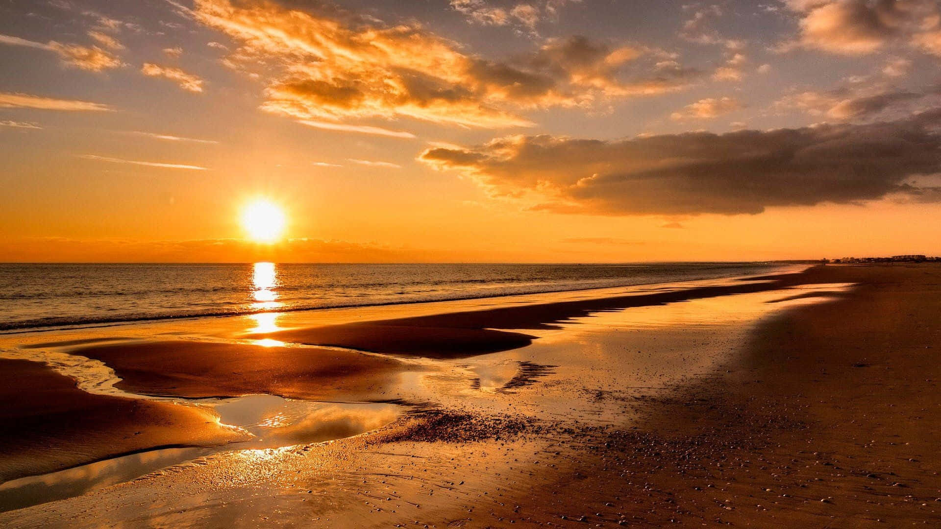 Enjoy the beauty of a spectacular beach sunset Wallpaper