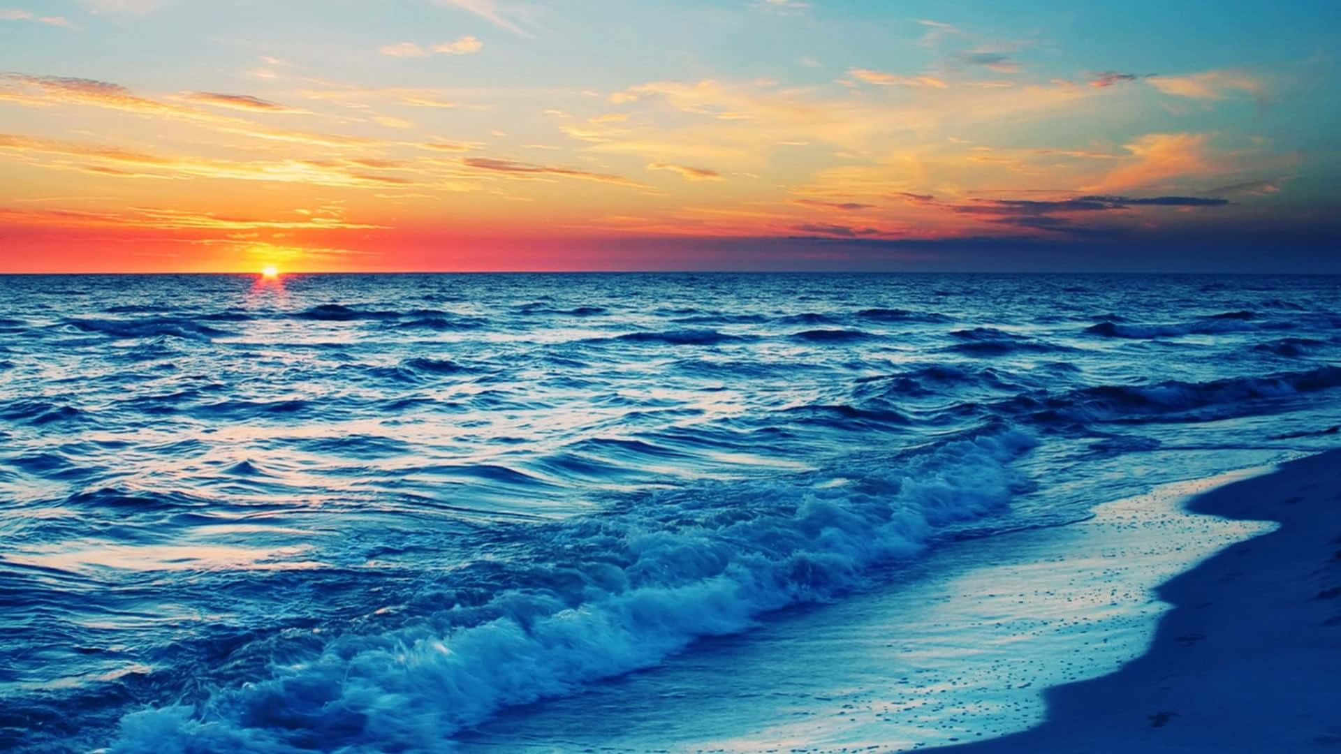 A golden sunset over a serene beach Wallpaper