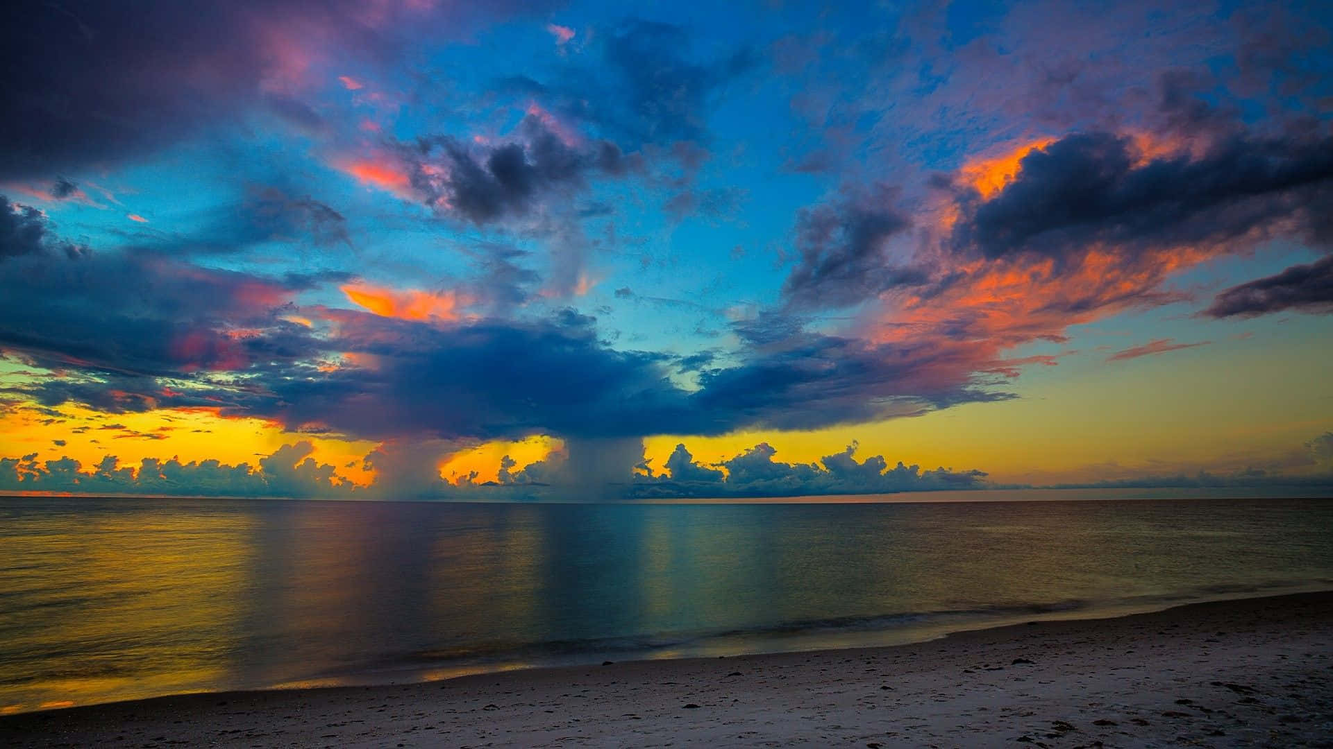 Bildeine Atemberaubende Aussicht Auf Den Sonnenuntergang Über Einem Strand Wallpaper