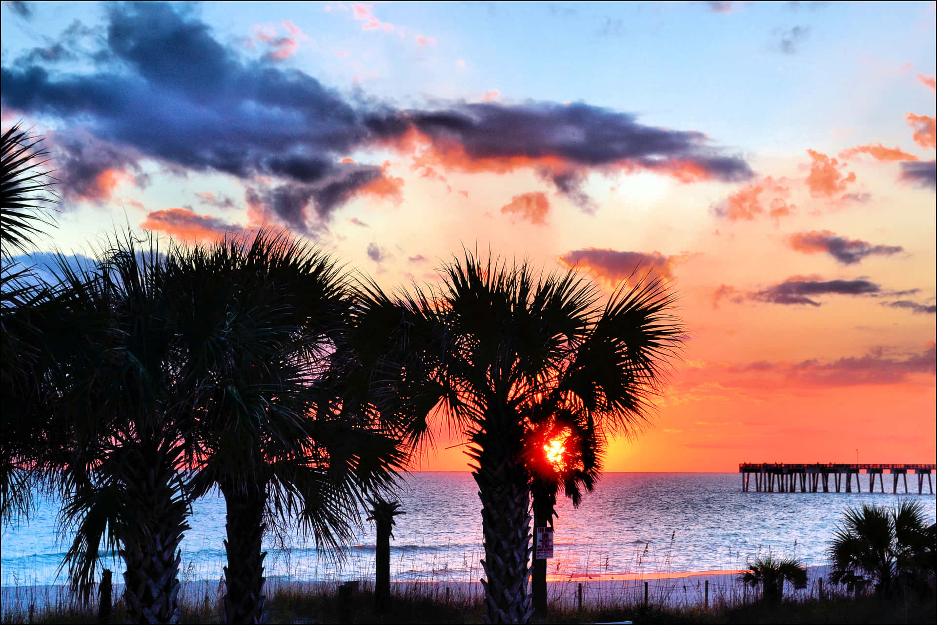 "Serene Silhouette: Enjoying the beauty of a beach sunset"