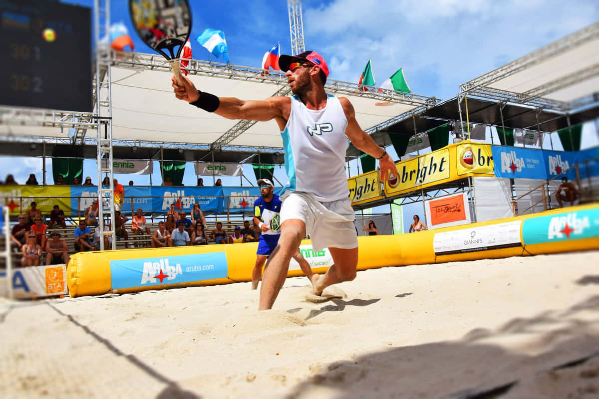 Exciting Beach Tennis Action Wallpaper