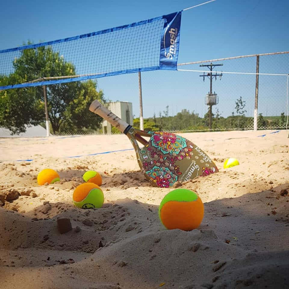 Download Beach Tennis Action: Players Having Fun on the Sand Wallpaper ...