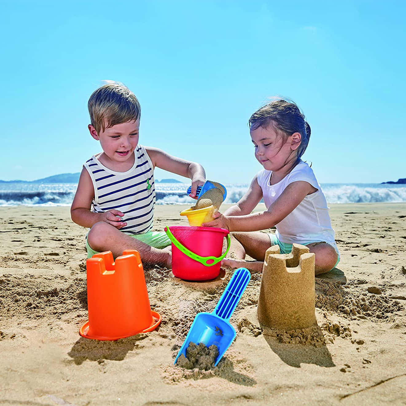 Colorful Beach Toys on Sandy Shore Wallpaper