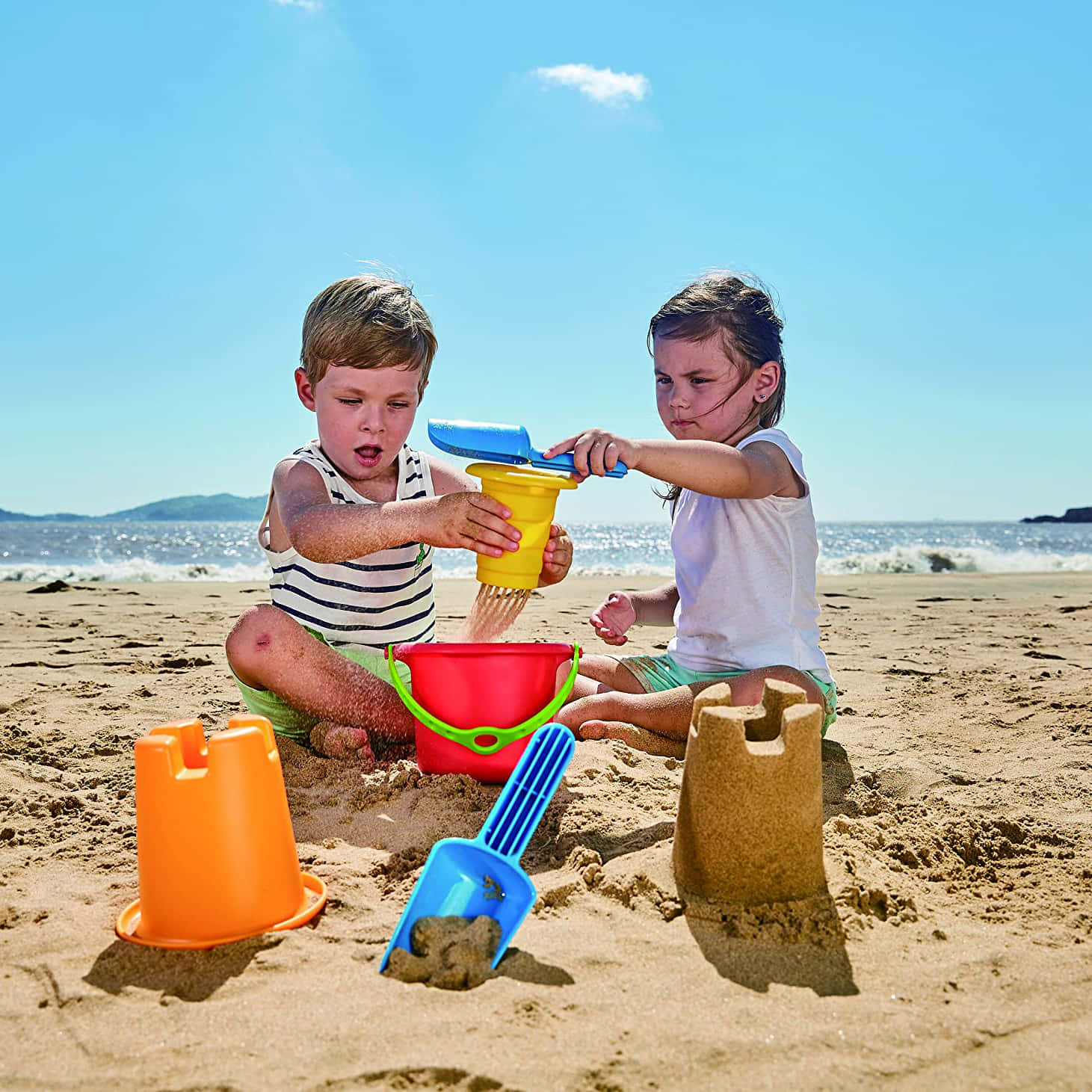 Fun and Colorful Beach Toys on Sandy Shore Wallpaper