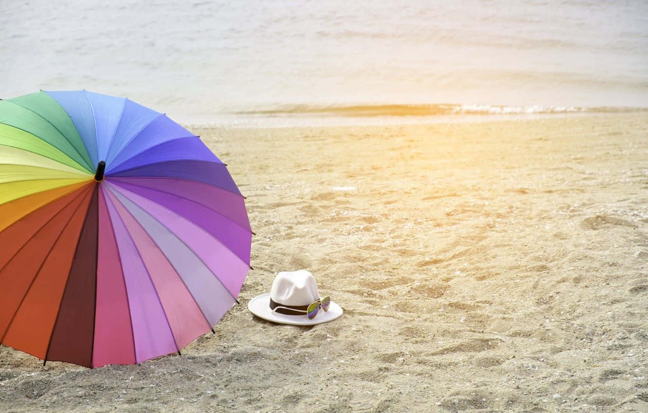 Díasde Verano Relajantes Bajo Una Vibrante Sombrilla En La Playa. Fondo de pantalla