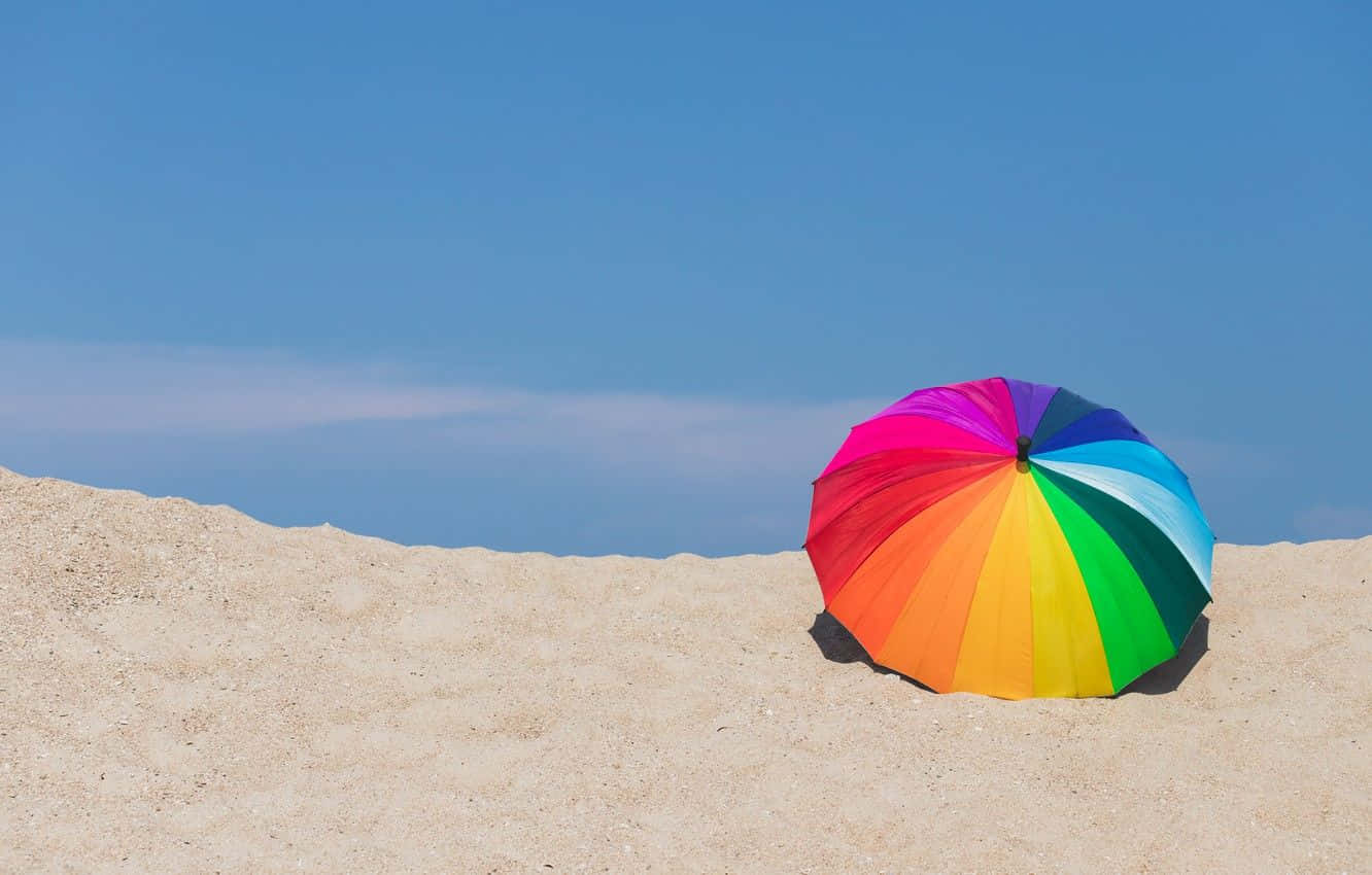 Vibrant Beach Umbrella on Sunny Seashore Wallpaper