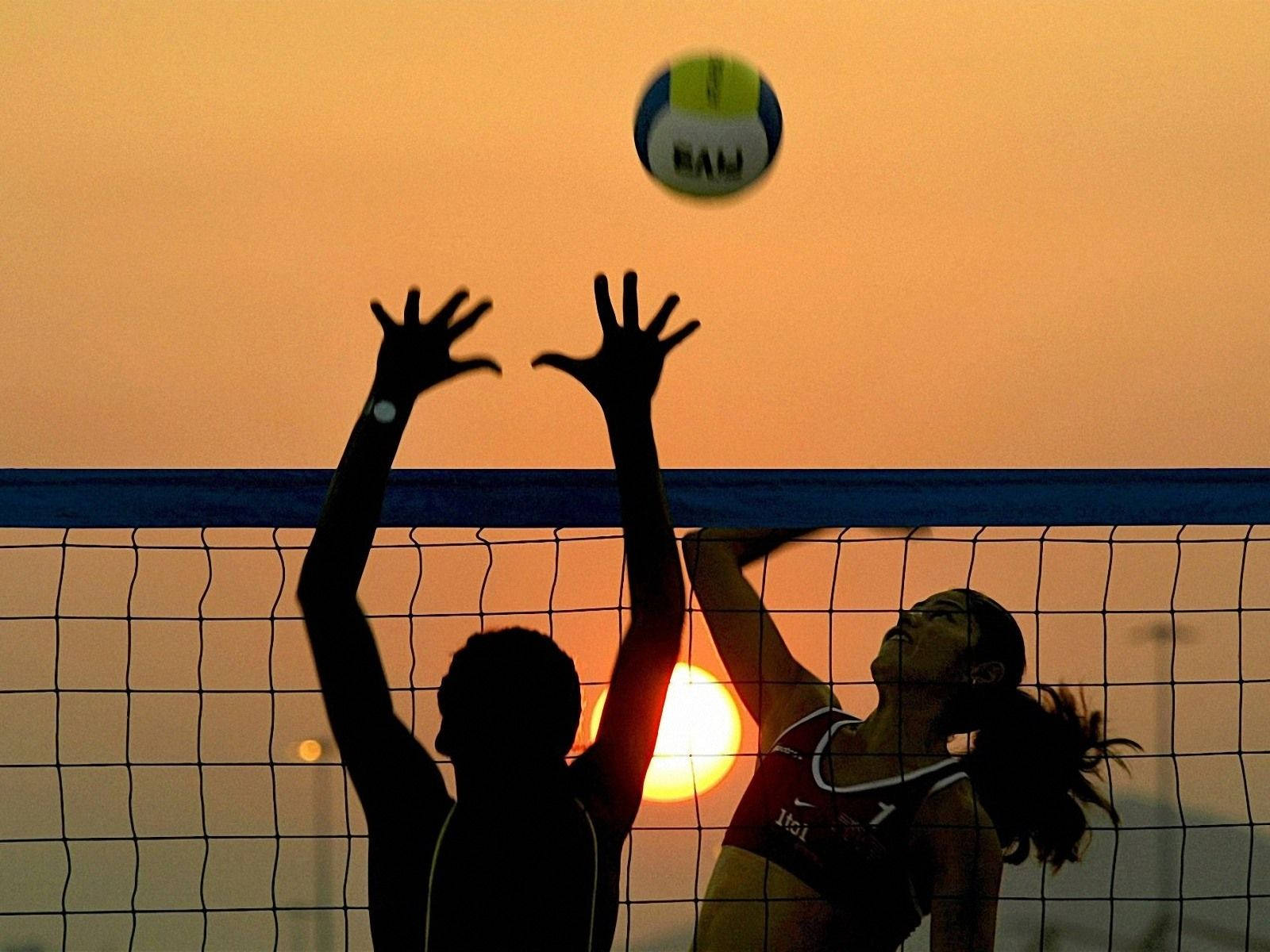 Beach Volleyball In Motion Blur At Sunset Wallpaper