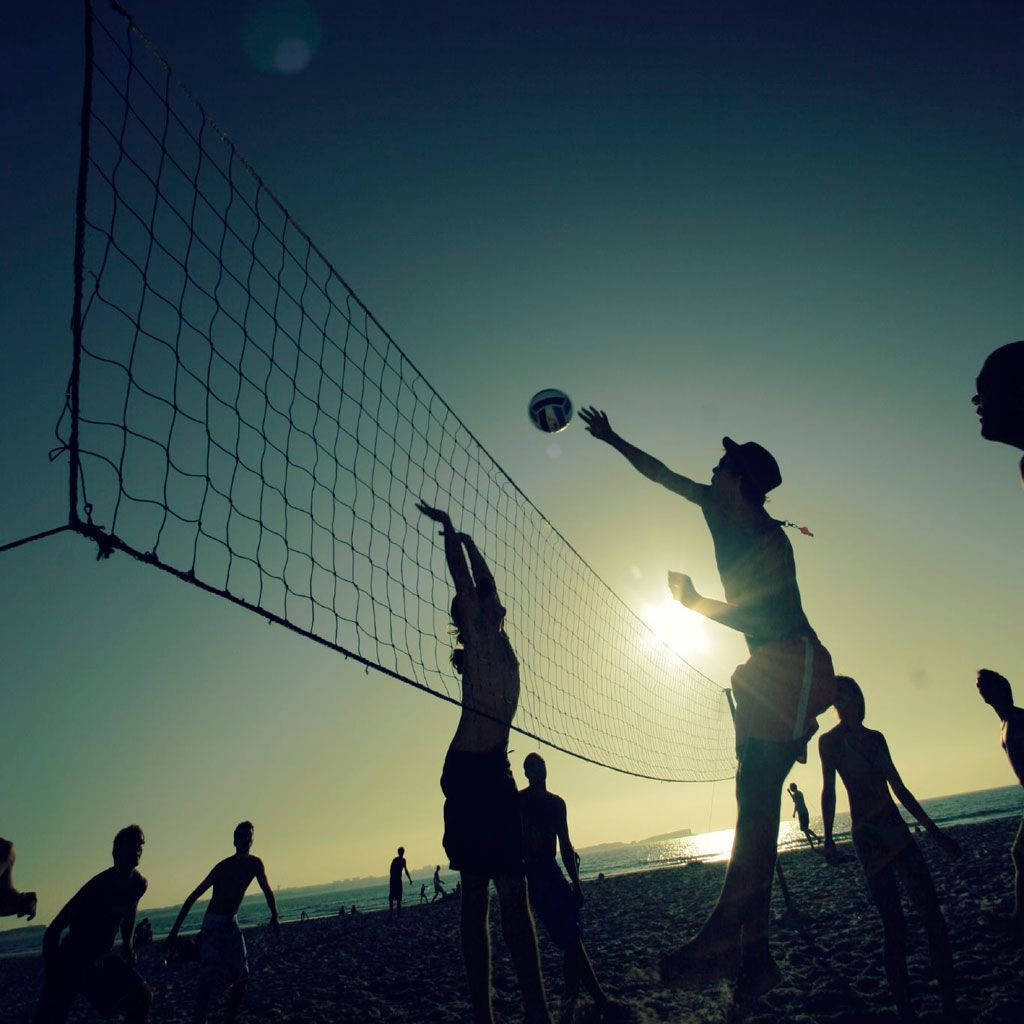 Beach Volleyball Silhouette On A Sunny Day Wallpaper
