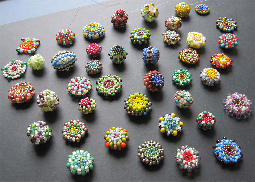 A Group Of Beads Are Arranged On A Table