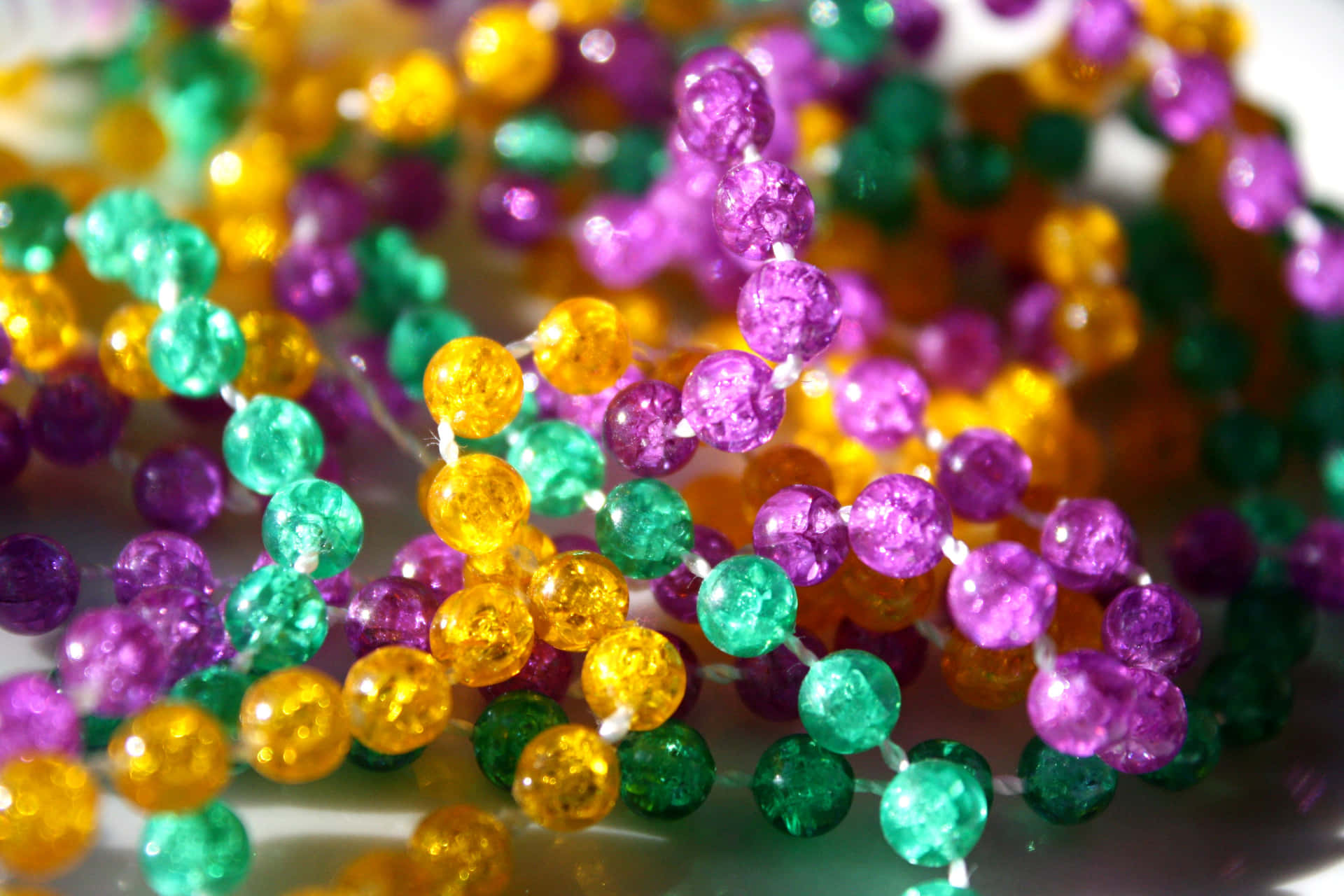 Mardi Gras Beads On A White Surface