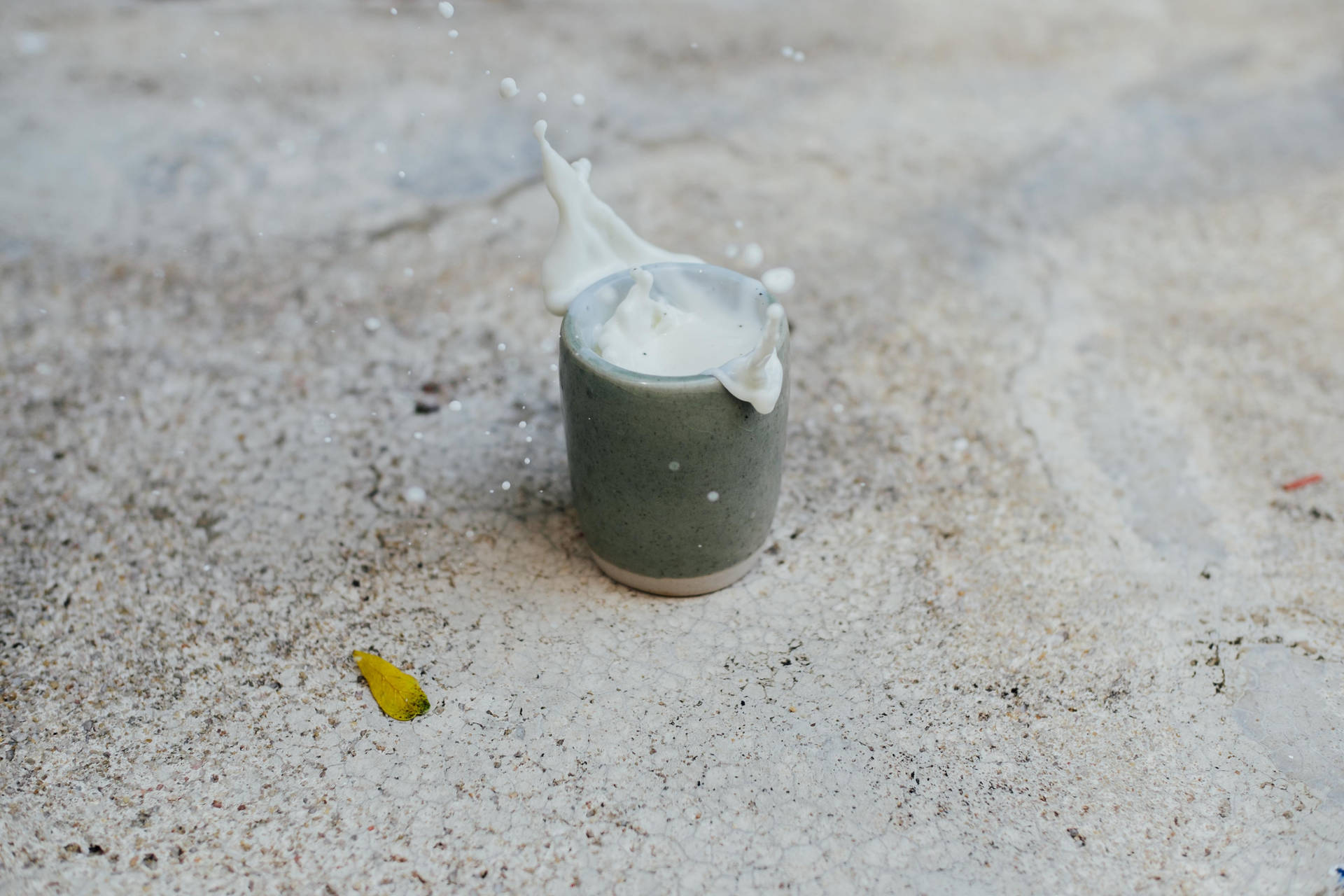 Beaker With Milk On Sand Wallpaper