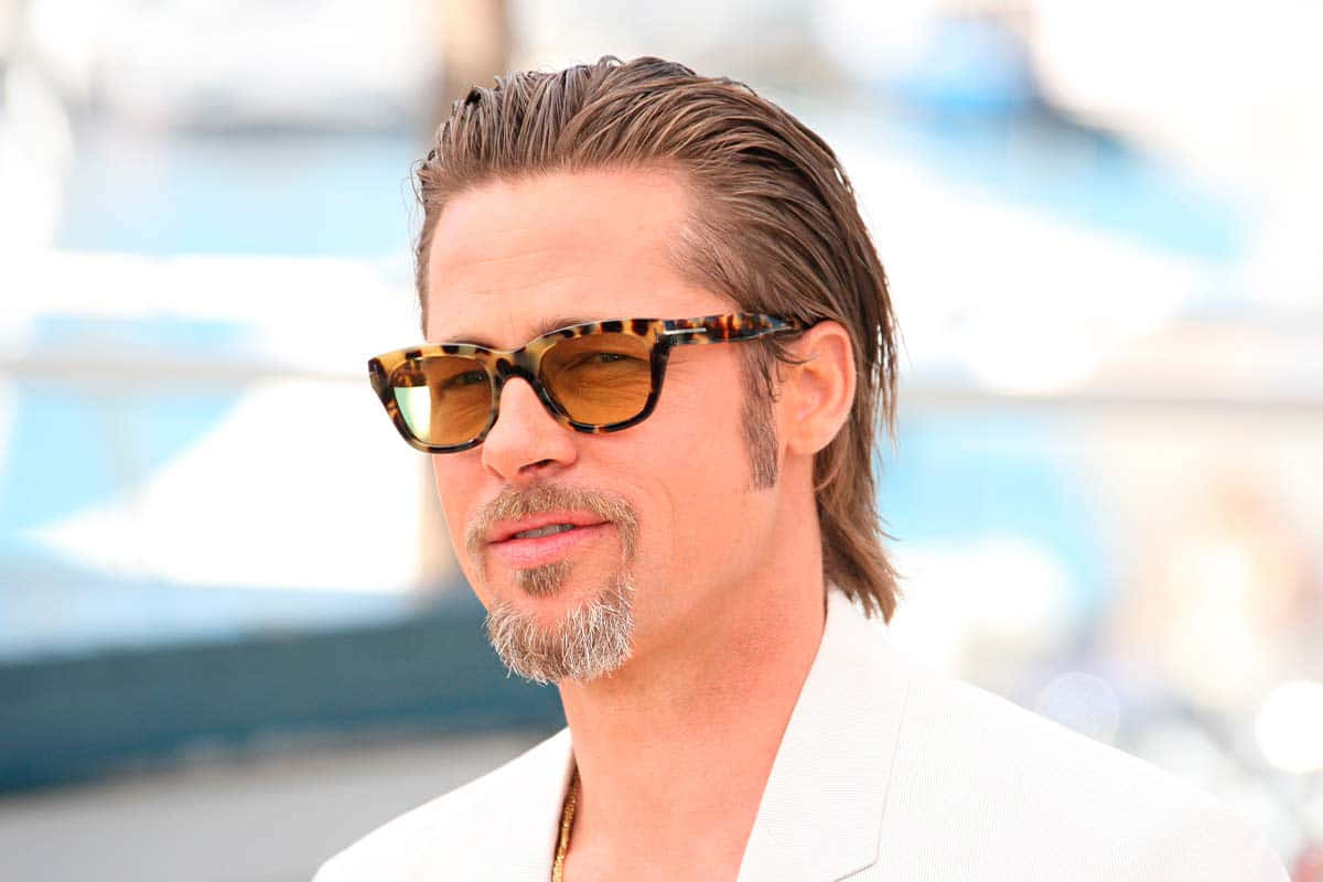 Brad Pitt Wearing Sunglasses And A White Jacket