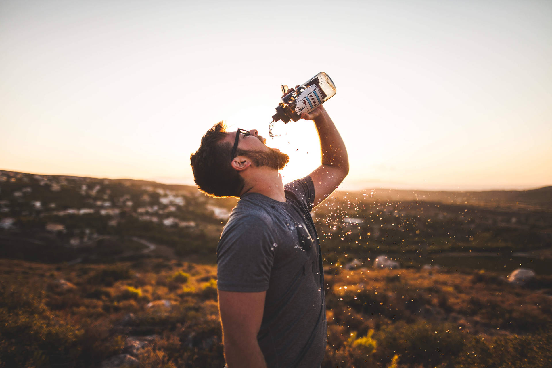Download Bearded Guy Drinking Water From Bottle Wallpaper 