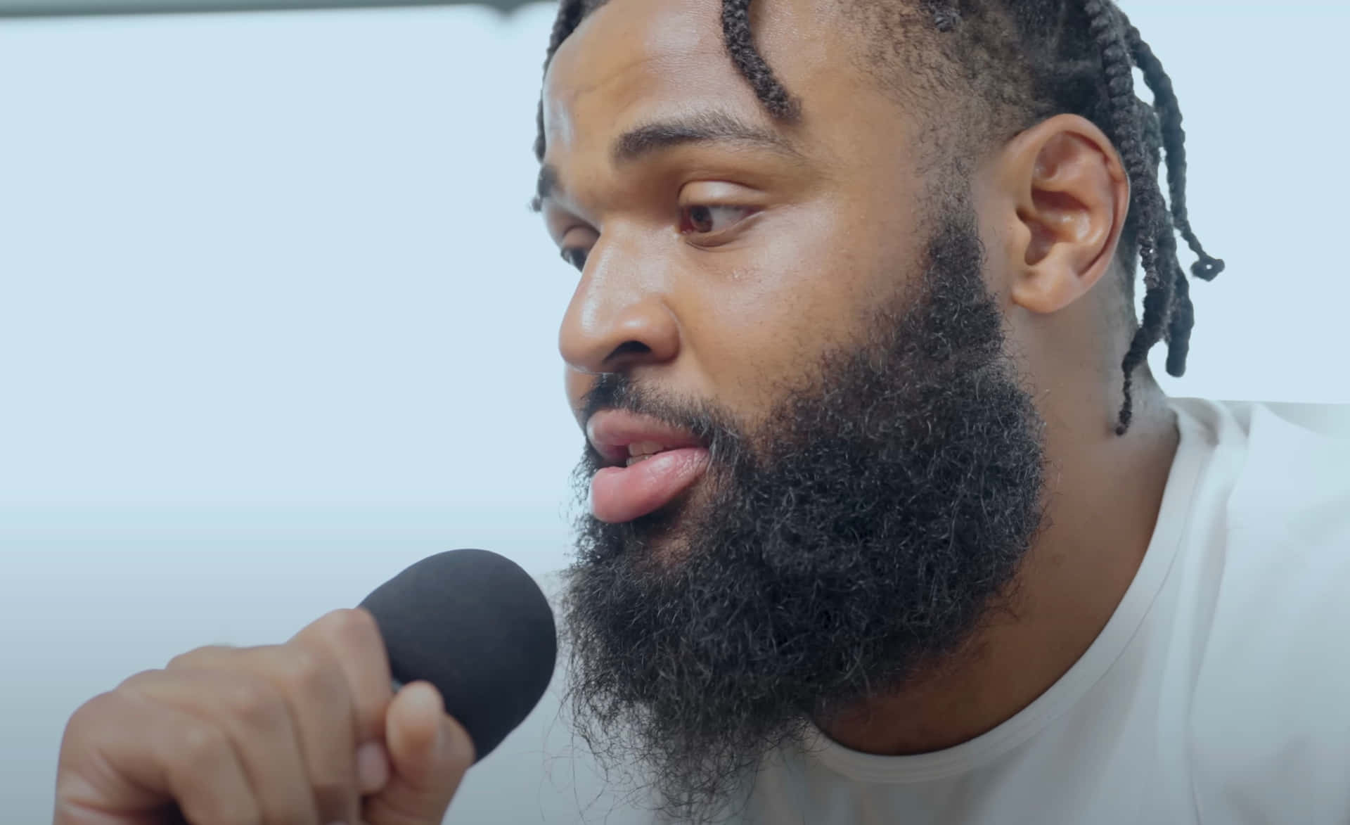 Bearded Man Speaking Into Microphone Wallpaper
