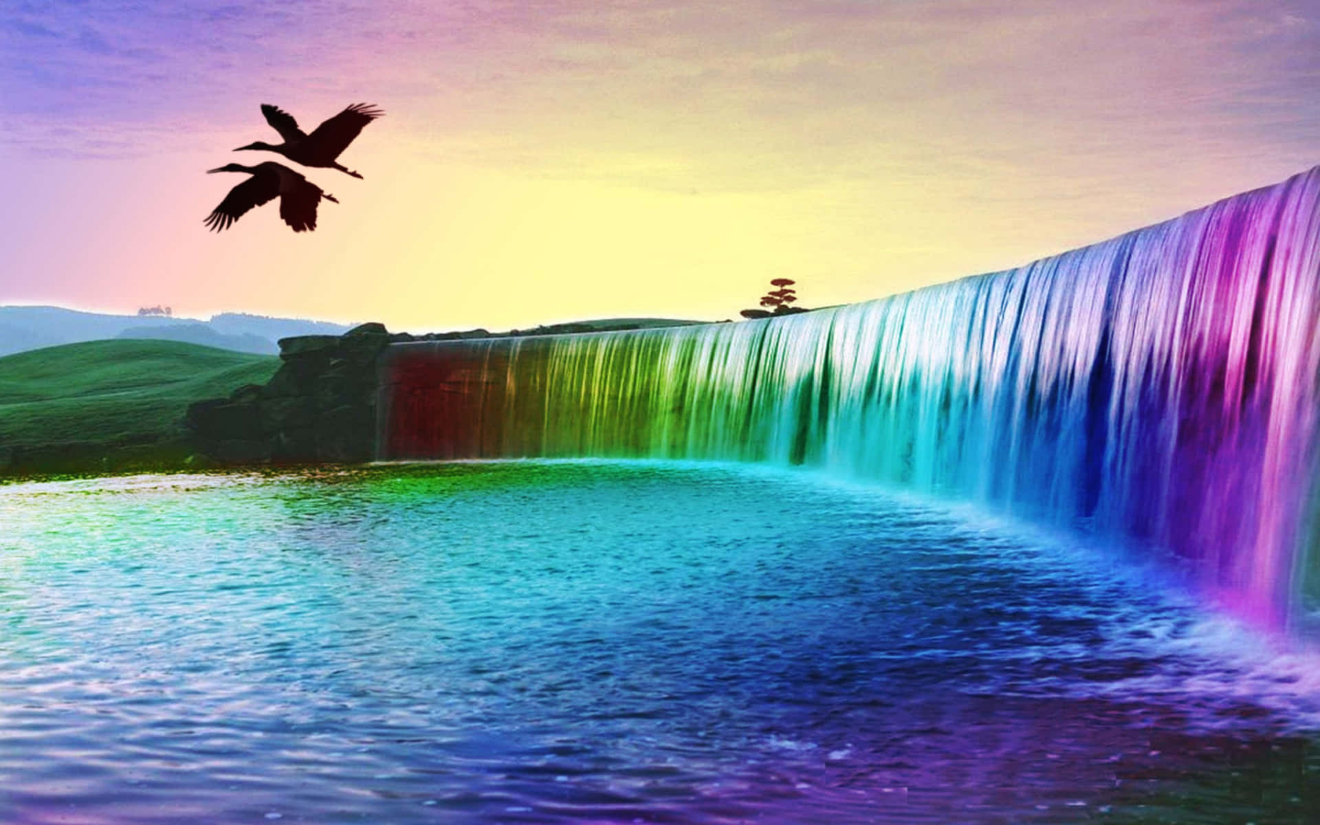 a rainbow colored waterfall with birds flying over it
