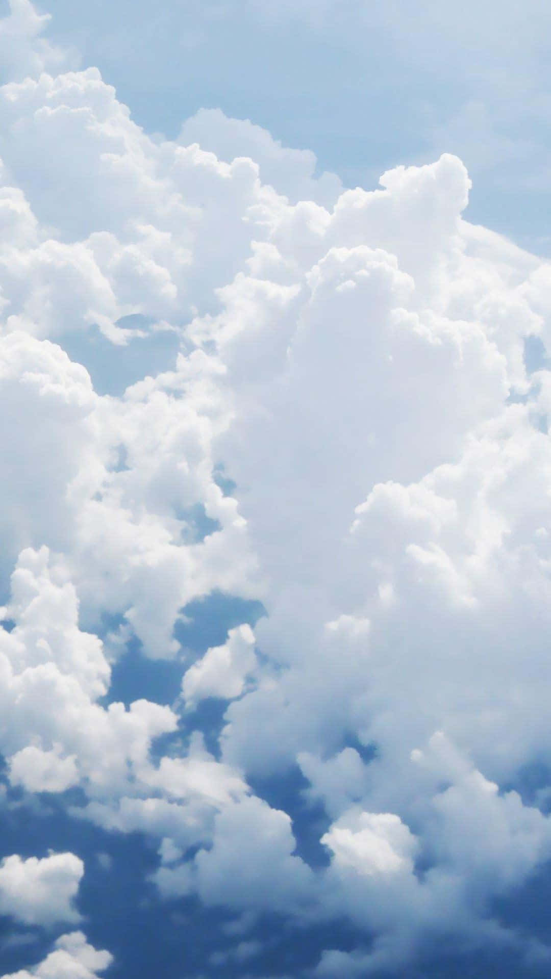 A beautiful view of the sky with white fluffy clouds Wallpaper