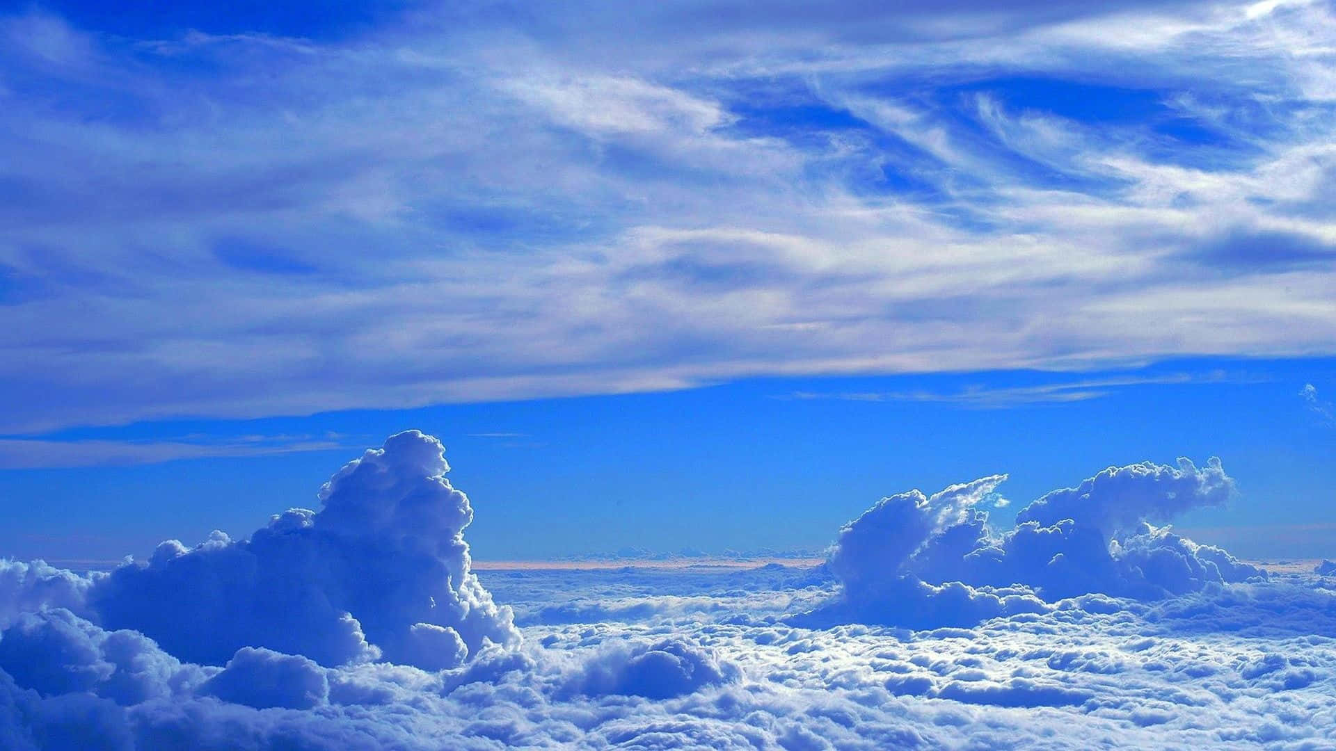 A beautiful and tranquil sky filled with soft and fluffy clouds Wallpaper