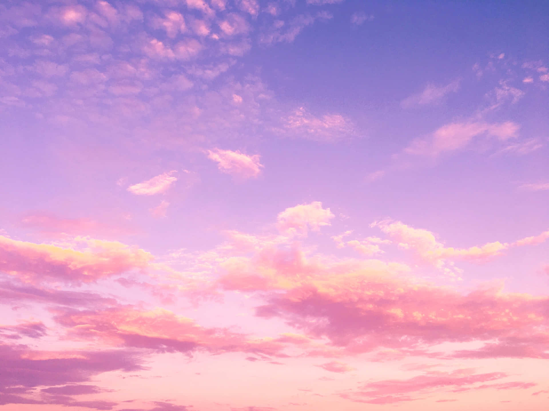 Breathtaking blue sky with beautiful gold and pink clouds Wallpaper