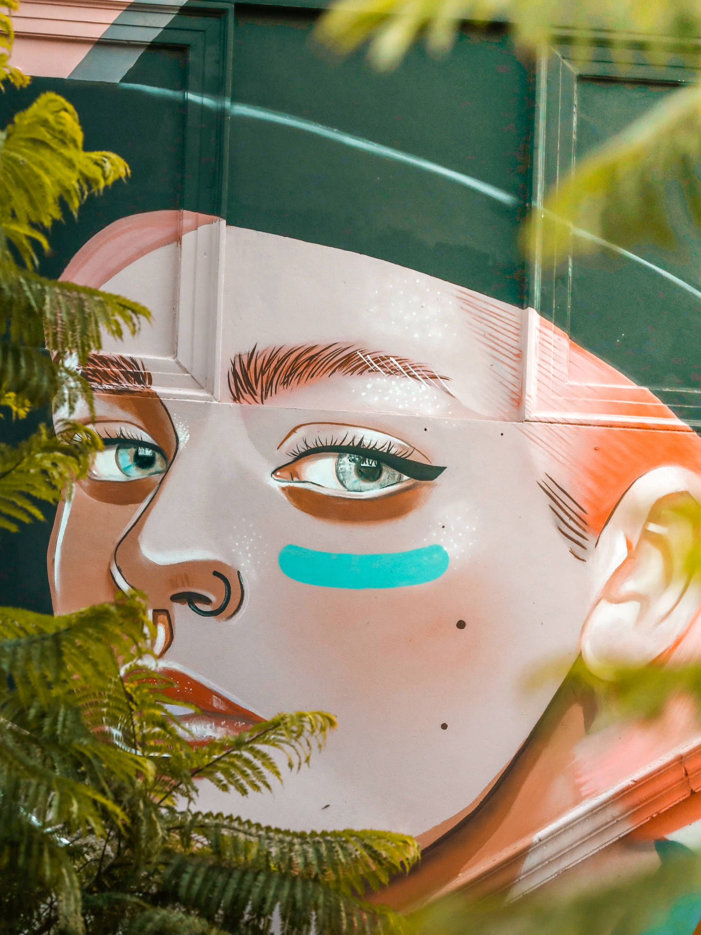 A stunning work of graffiti art featuring a beautiful face Wallpaper