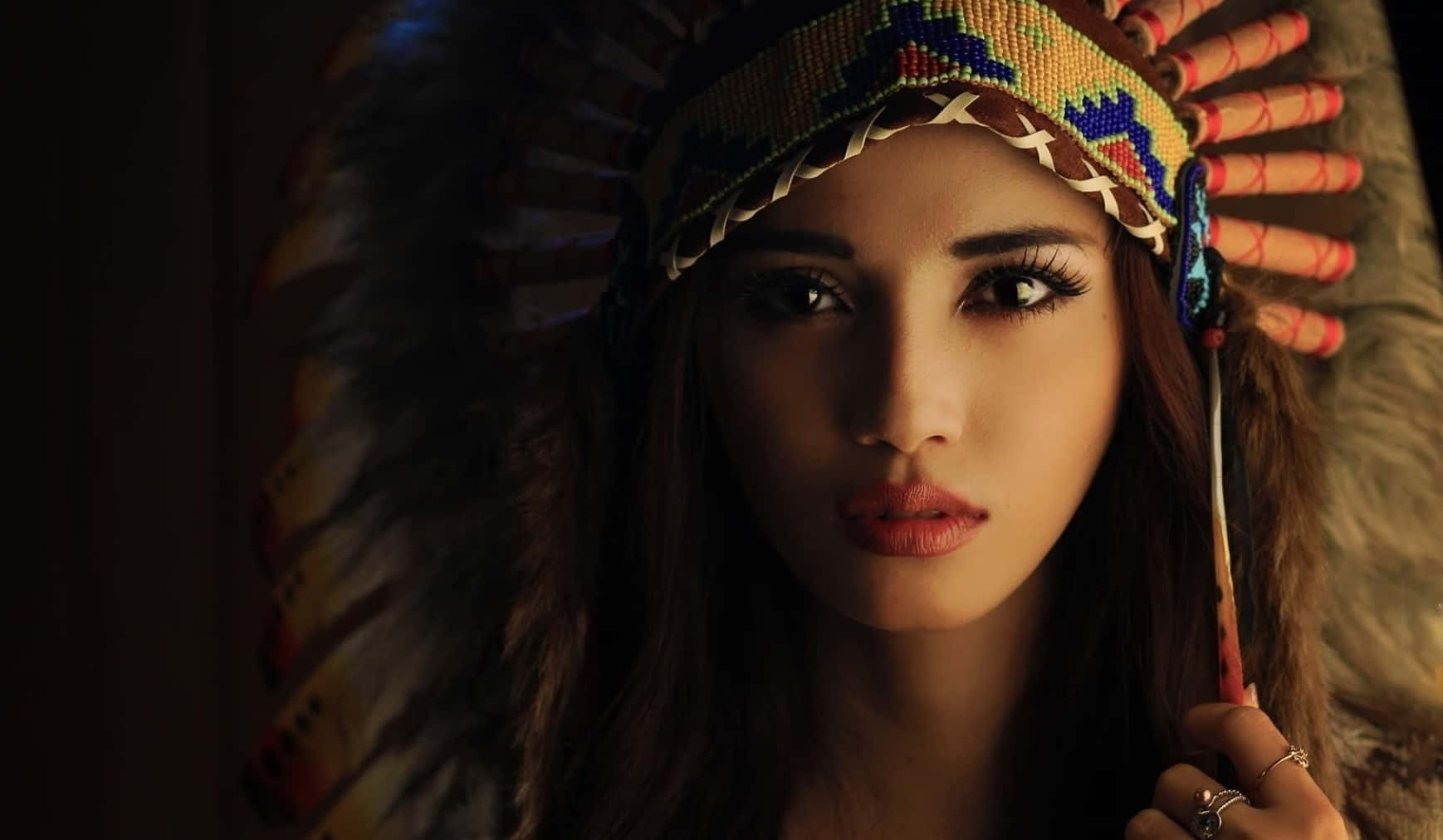 A Woman In An Indian Headdress Posing For A Picture Wallpaper