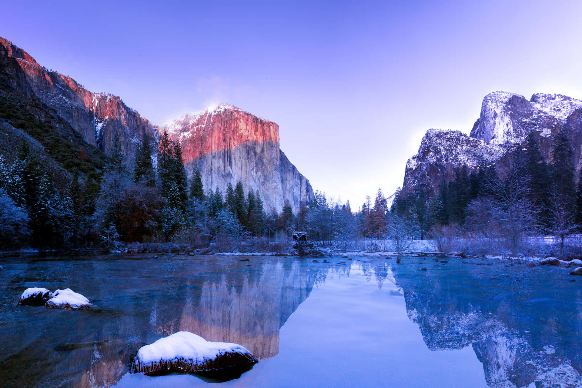 Soak in the peaceful beauty of a snow-capped mountain lake. Wallpaper
