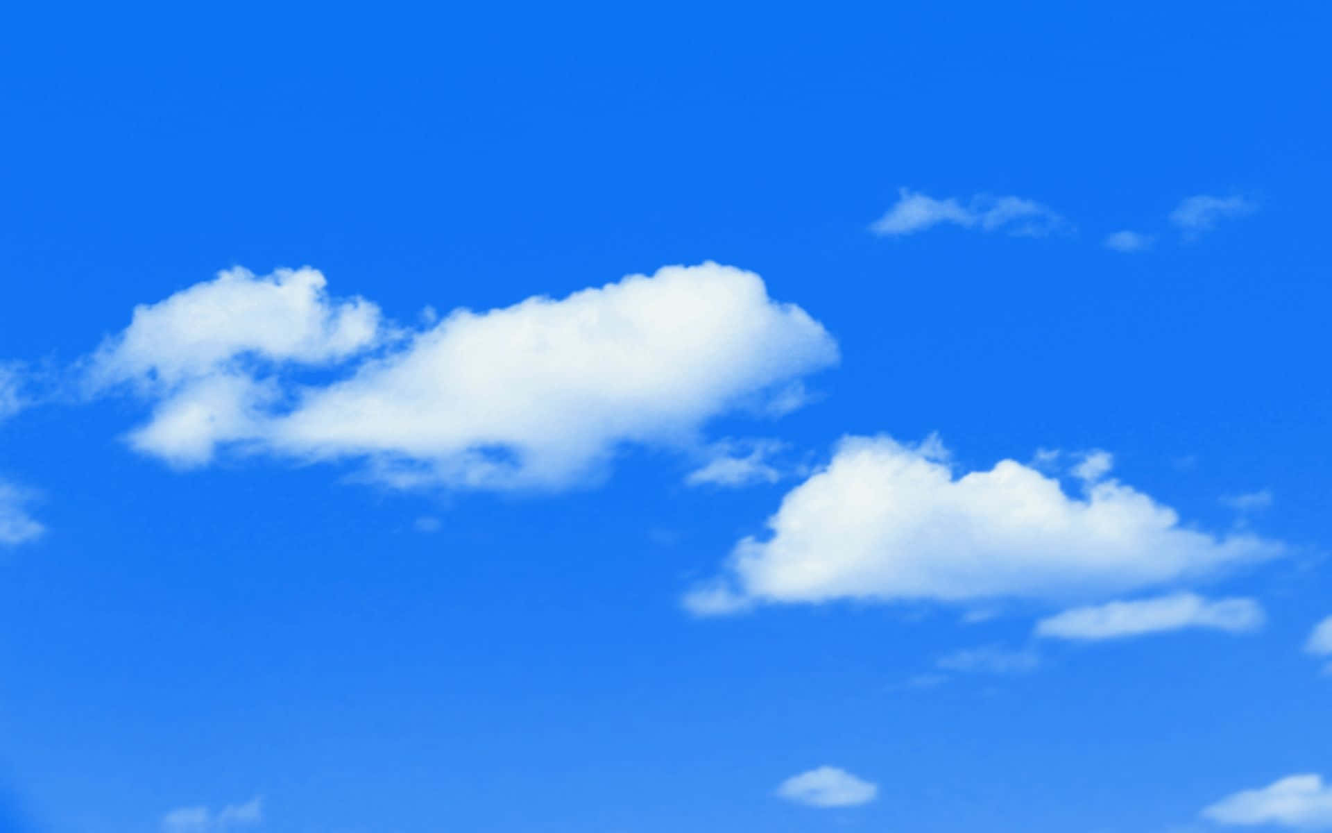 A Blue Sky With White Clouds In The Background