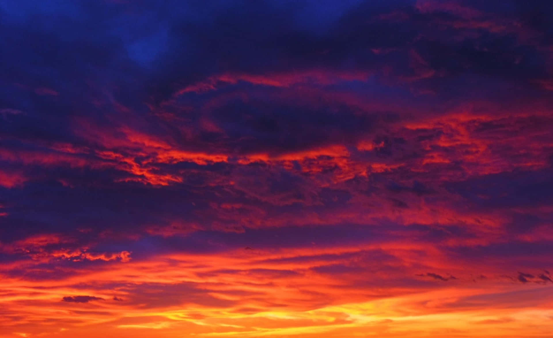 A Colorful Sunset With Clouds In The Sky