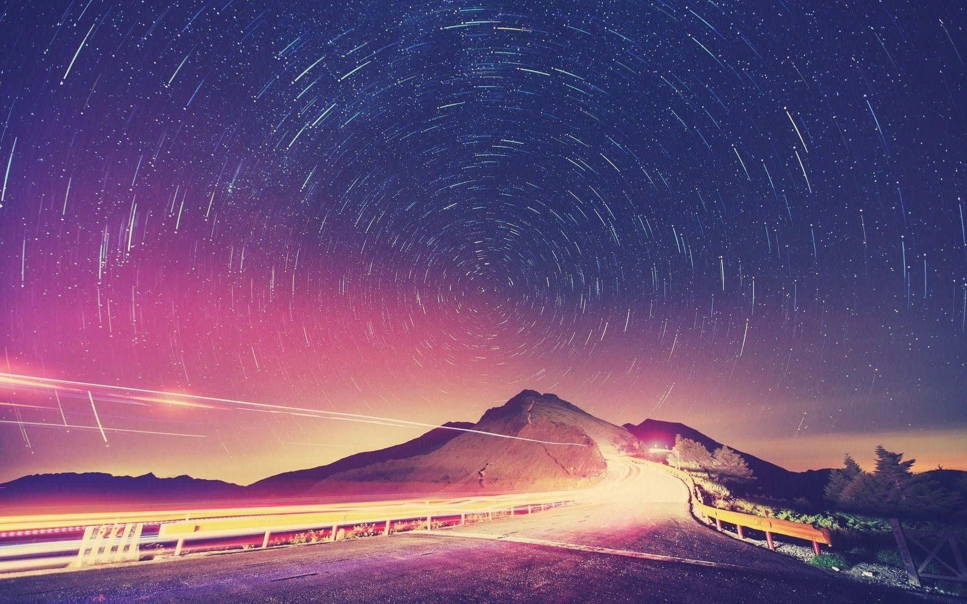 A Road With Star Trails In The Sky