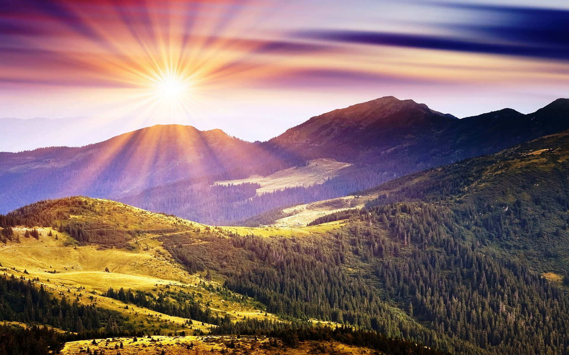 A Mountain Range With The Sun Rising Over It Wallpaper
